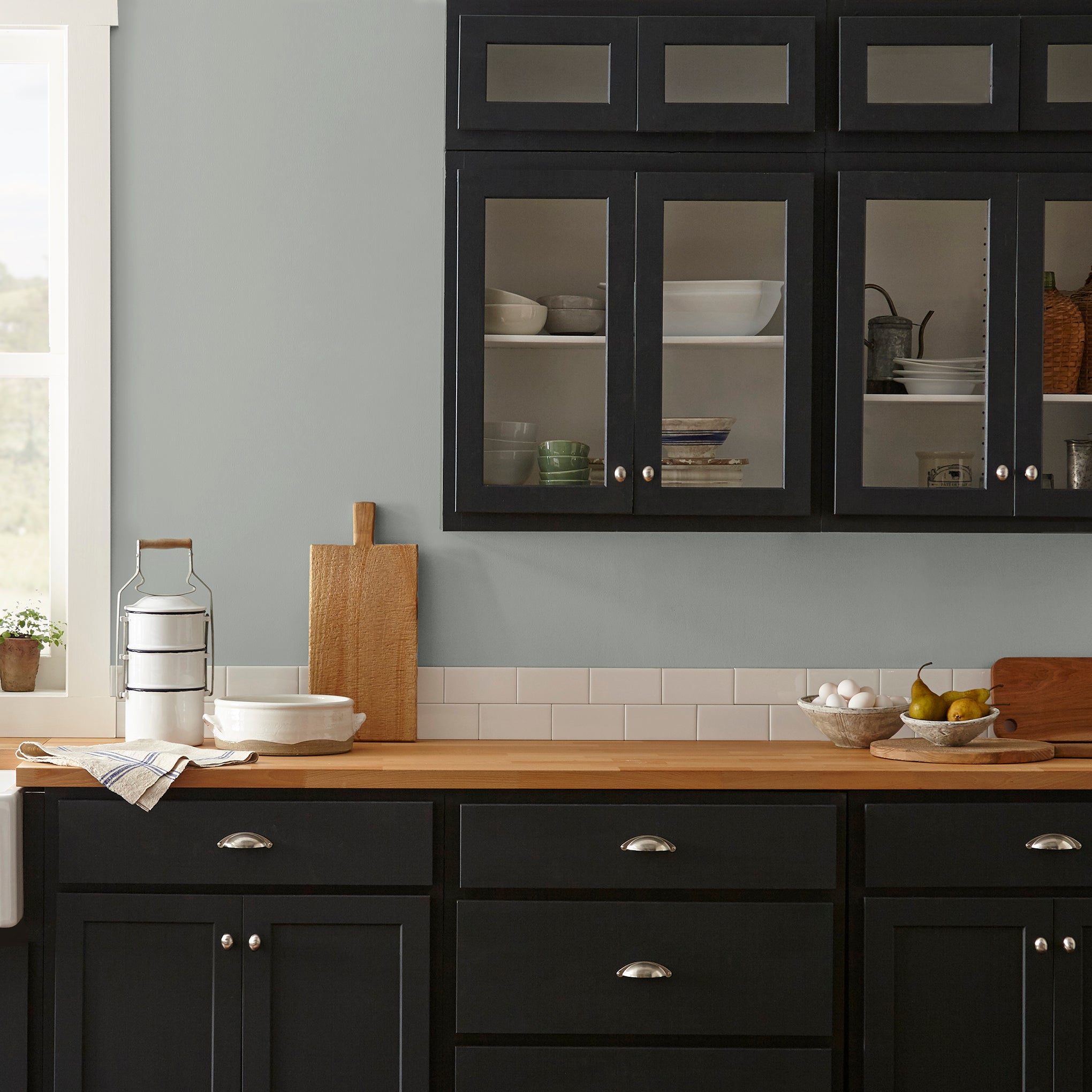 An overcast gray with hints of pale blue and green interior paint named weathered windmill shown on kitchen wall