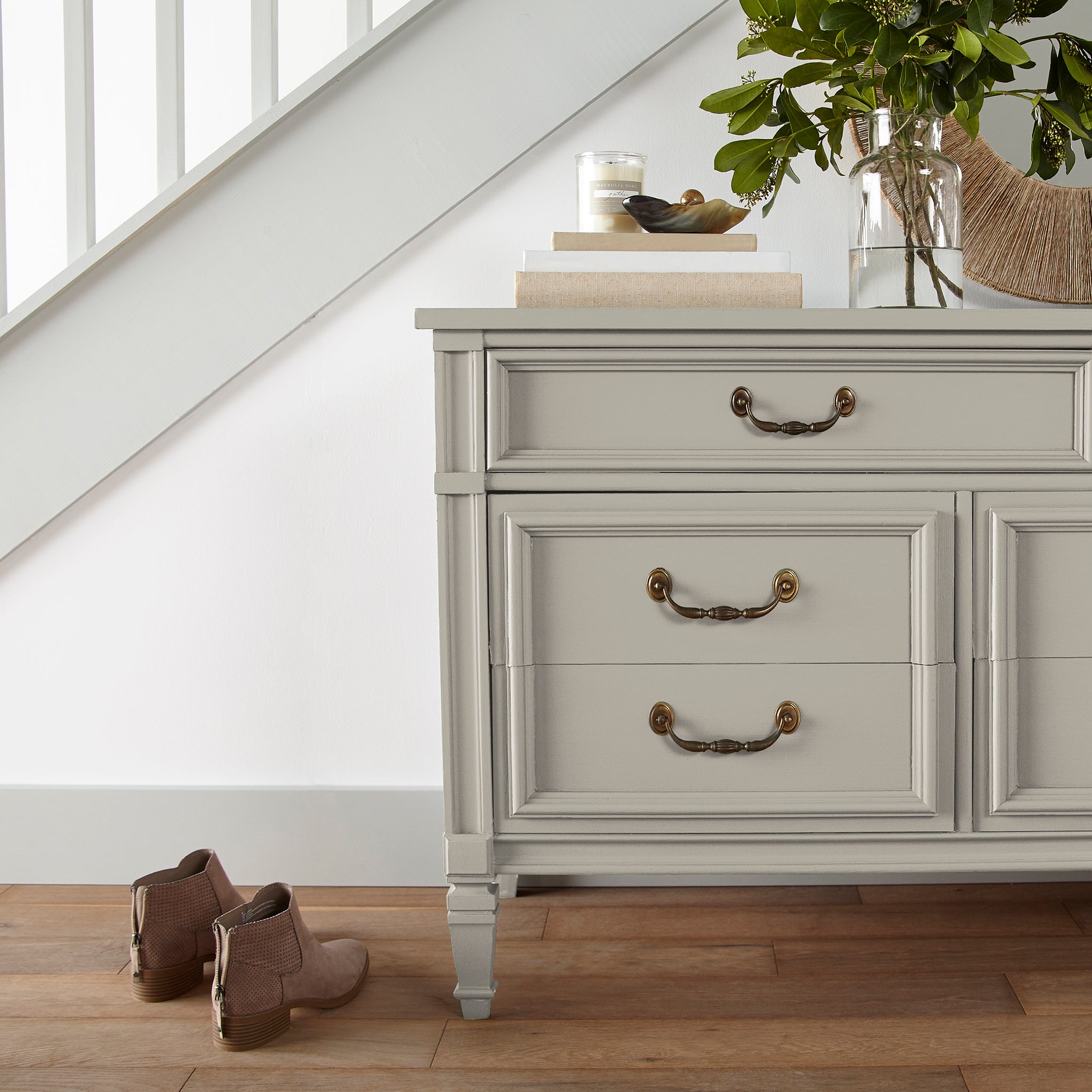 medium grey with tan undertones paint named gatherings shown painted on entryway cabinet