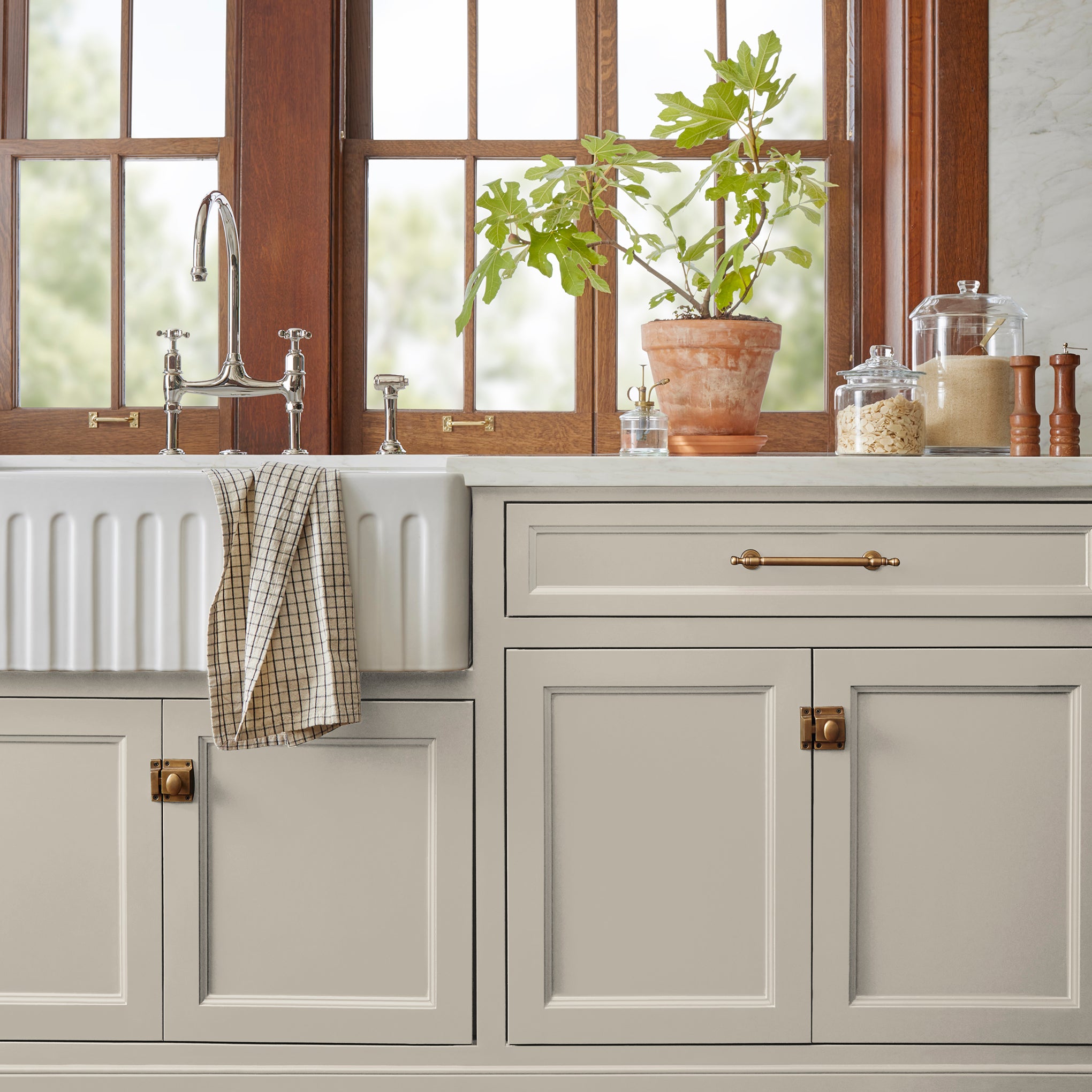 medium grey with tan undertones paint named gatherings shown painted on kitchen cabinet