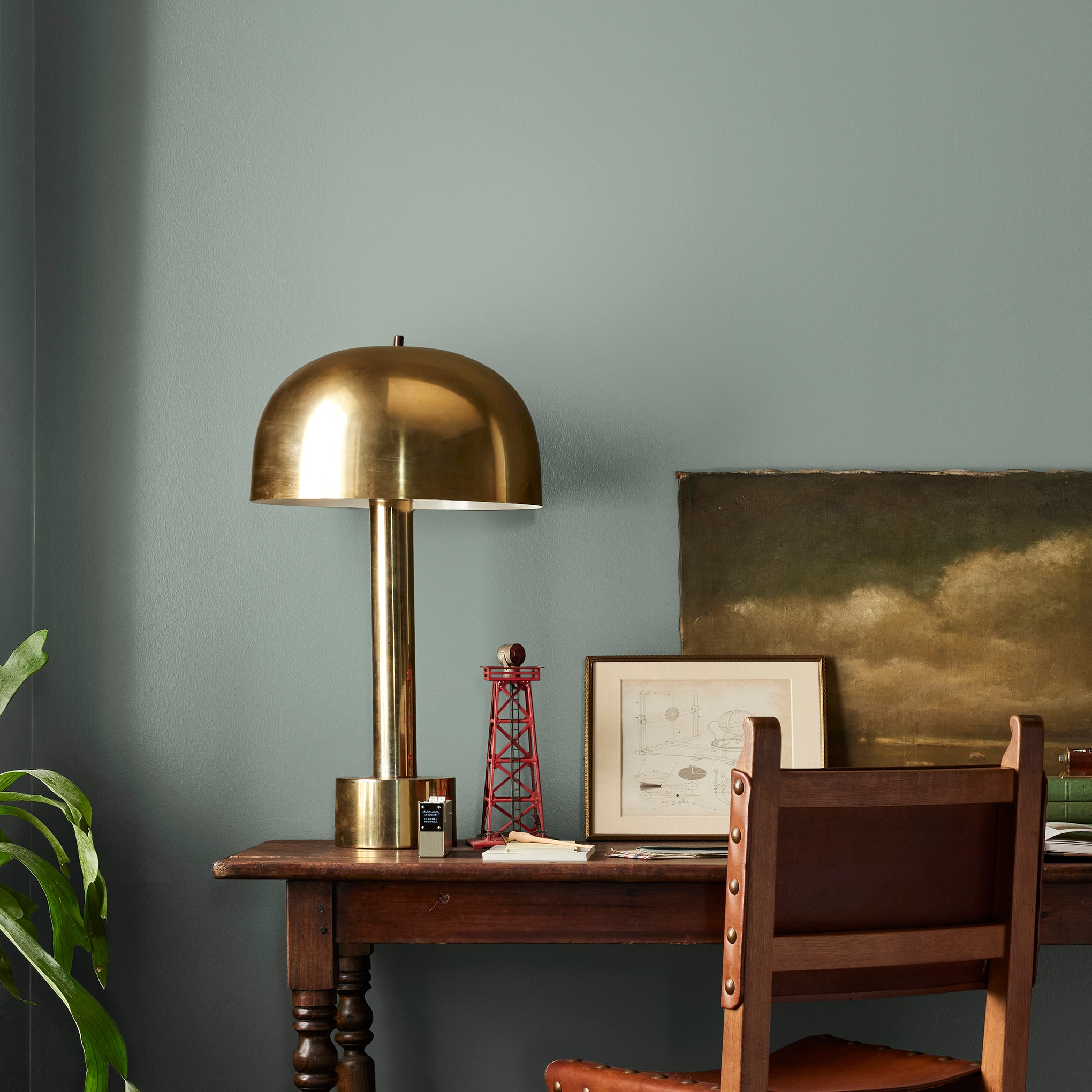 Deep gray with hues of rich blue and sage green interior paint named silverado sage shown painted on bedroom wall