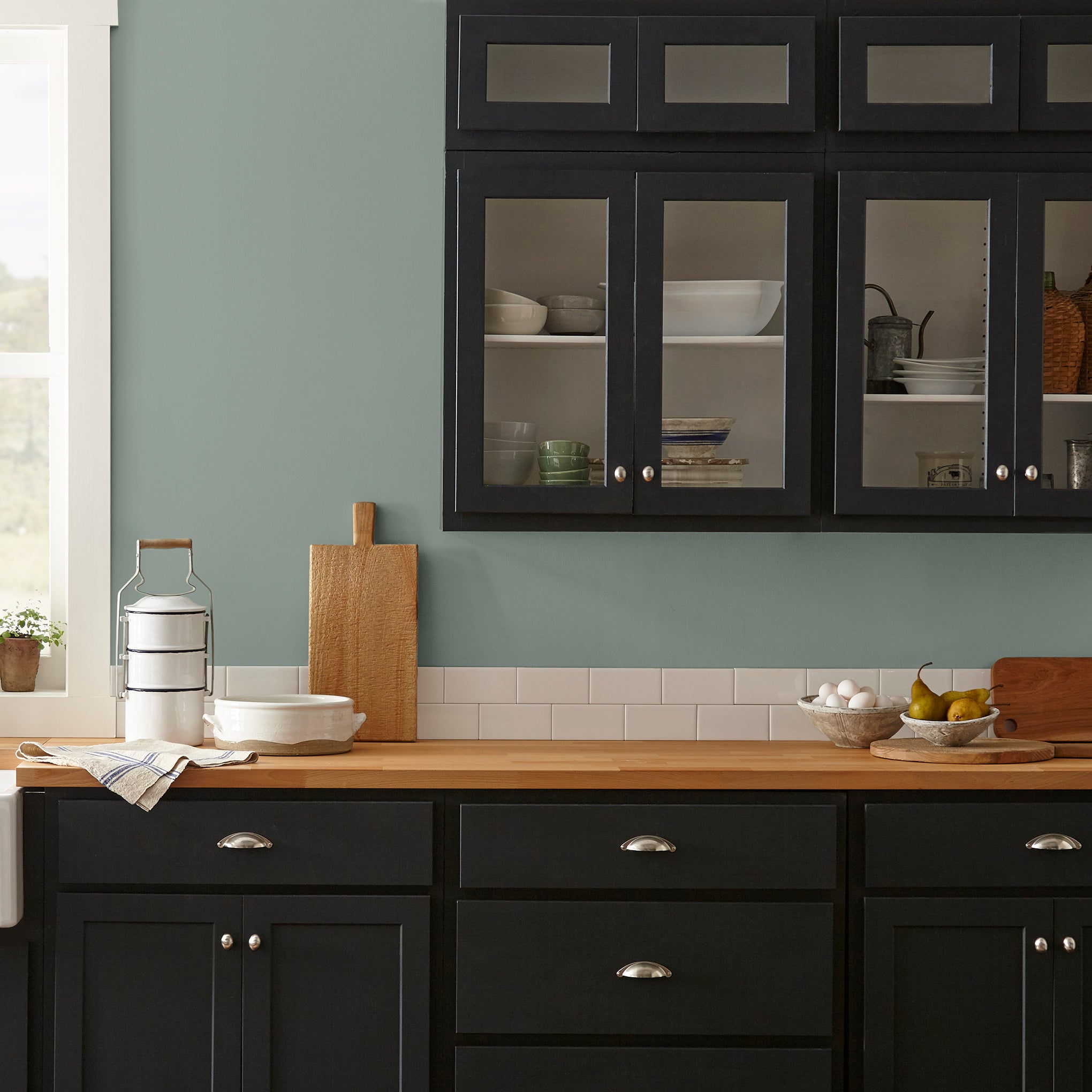 Deep gray with hues of rich blue and sage green interior paint named silverado sage shown painted on kitchen wall