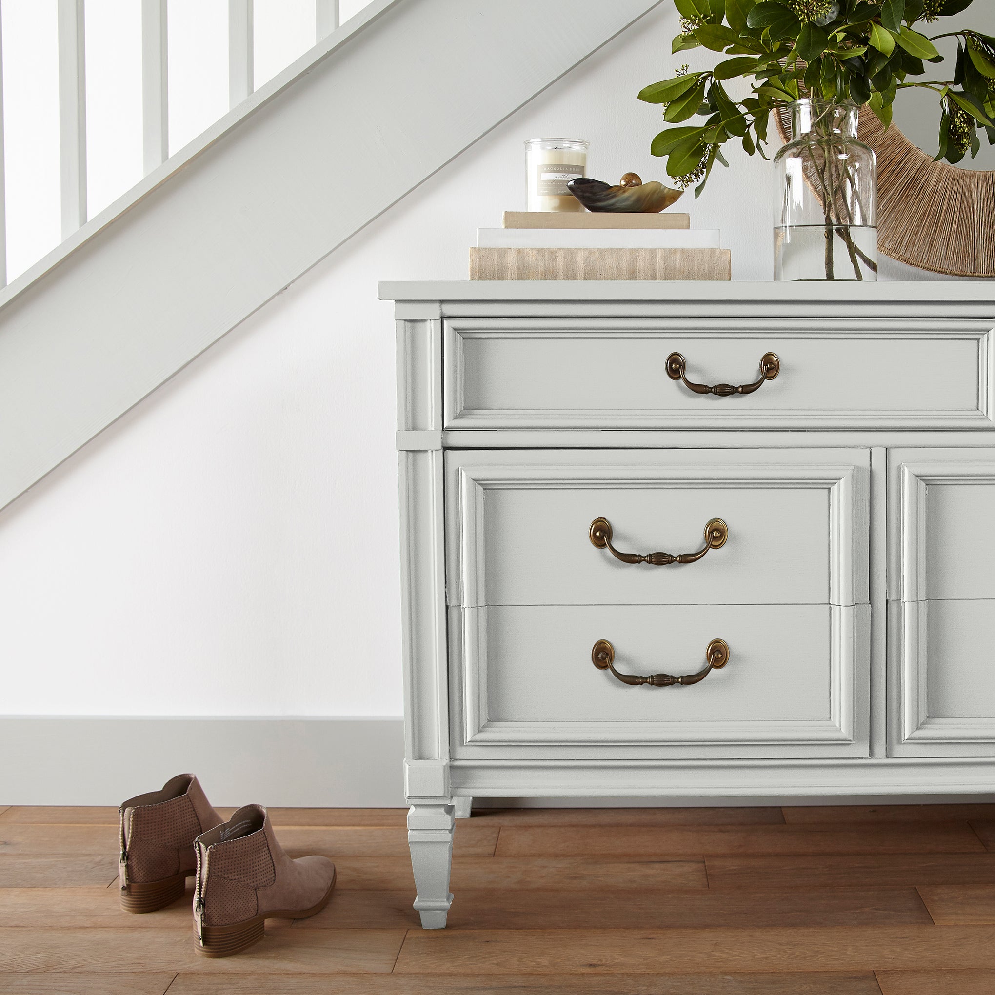 A pure white trim and cabinetry paint named true white shown painted on entryway cabinet