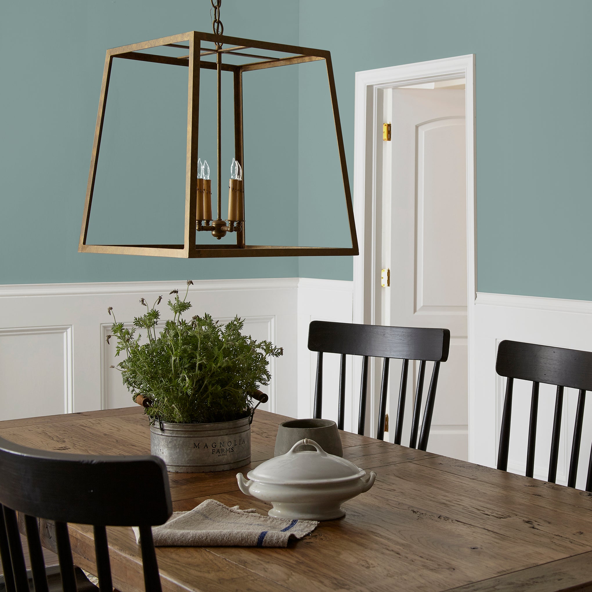 medium grey-aqua blue interior paint named sir drake shown painted on dining room wall