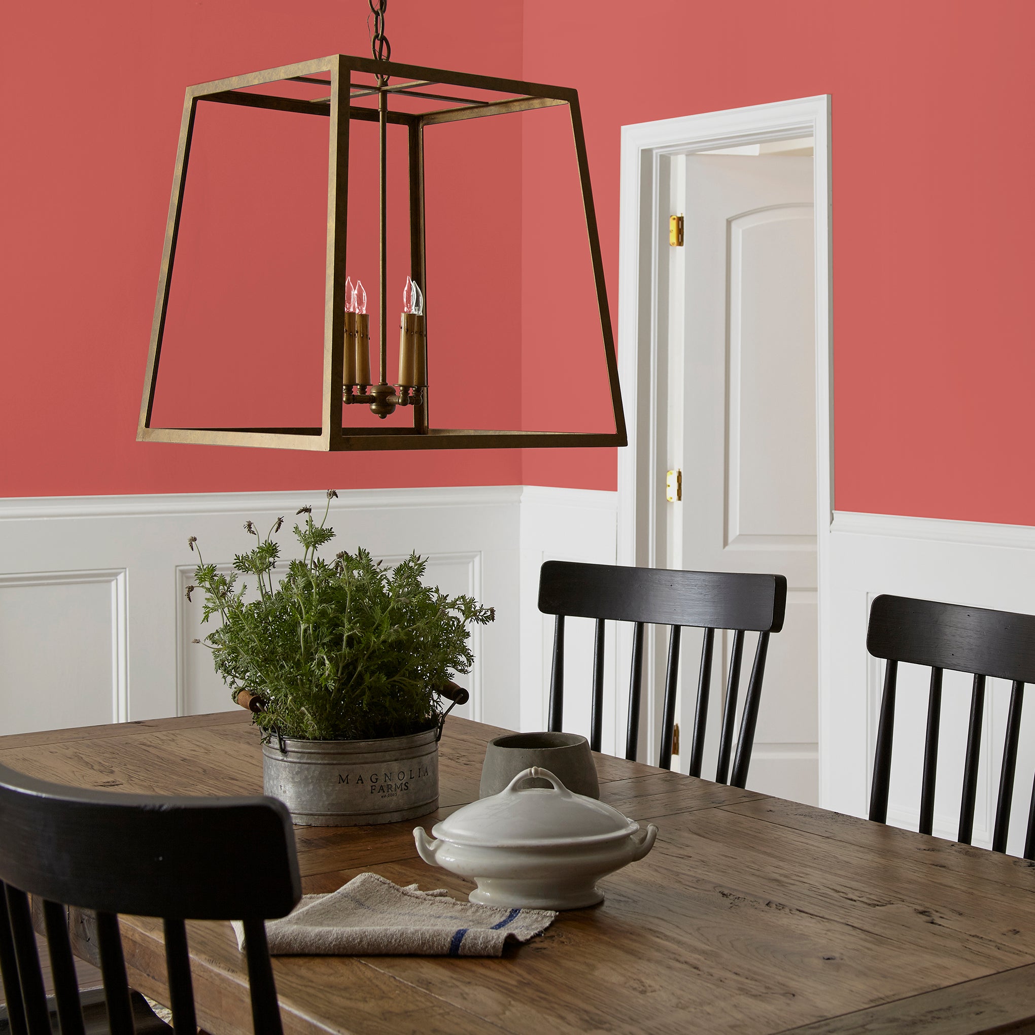 vibrant red with orange undertones interior paint named ripened tomato shown painted on dining room wall