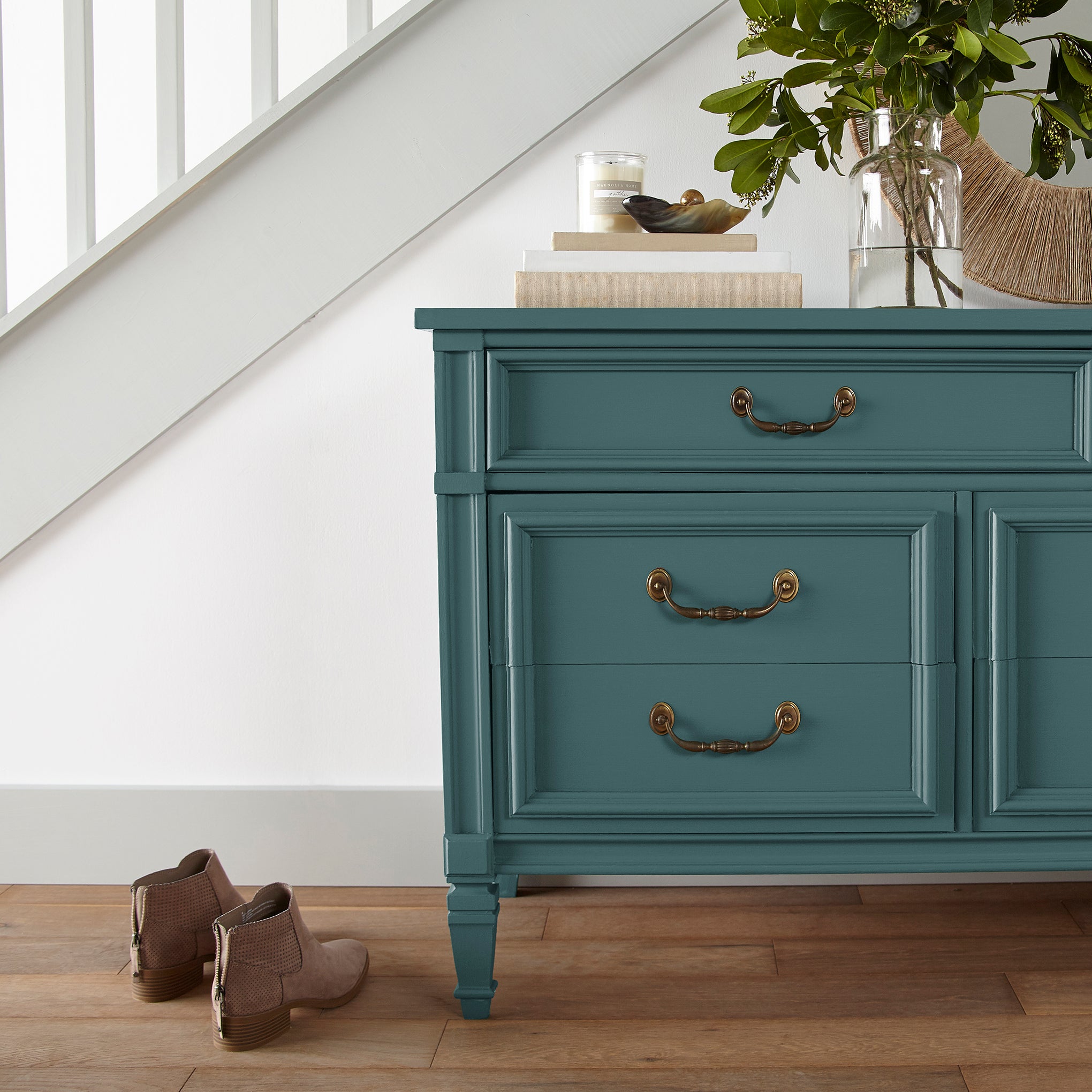 Denim inspired blue paint named weekend shown painted on entryway cabinet