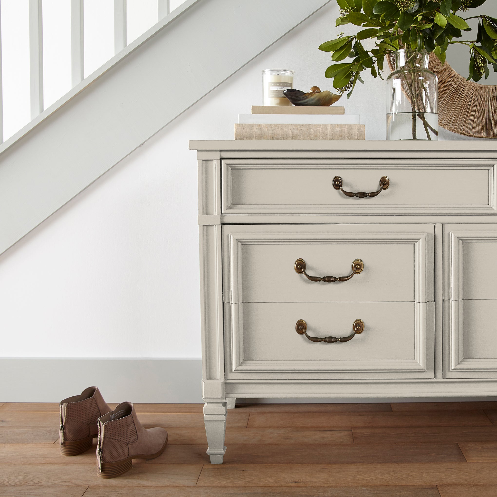 A warm honey yellow interior paint named carter creme shown painted on entryway cabinet
