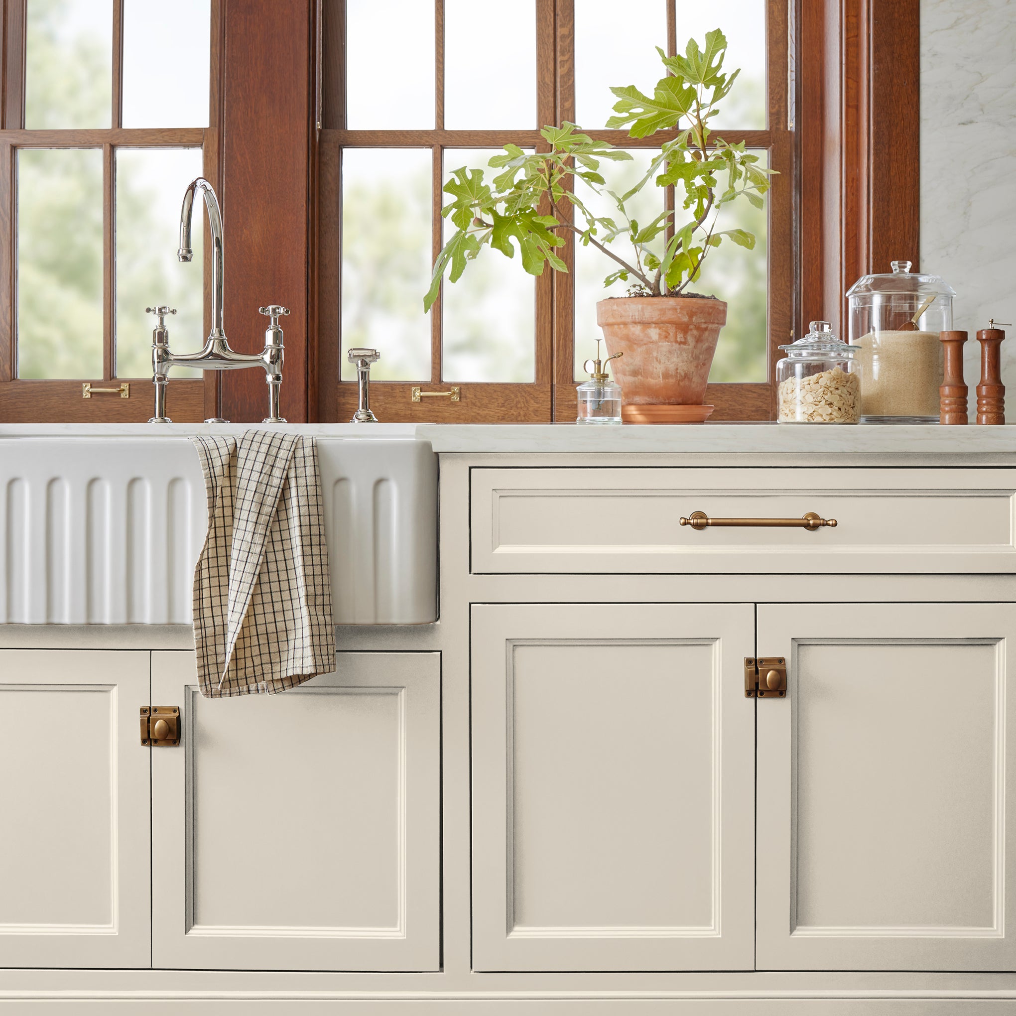 A warm honey yellow interior paint named carter creme shown painted on kitchen cabinet
