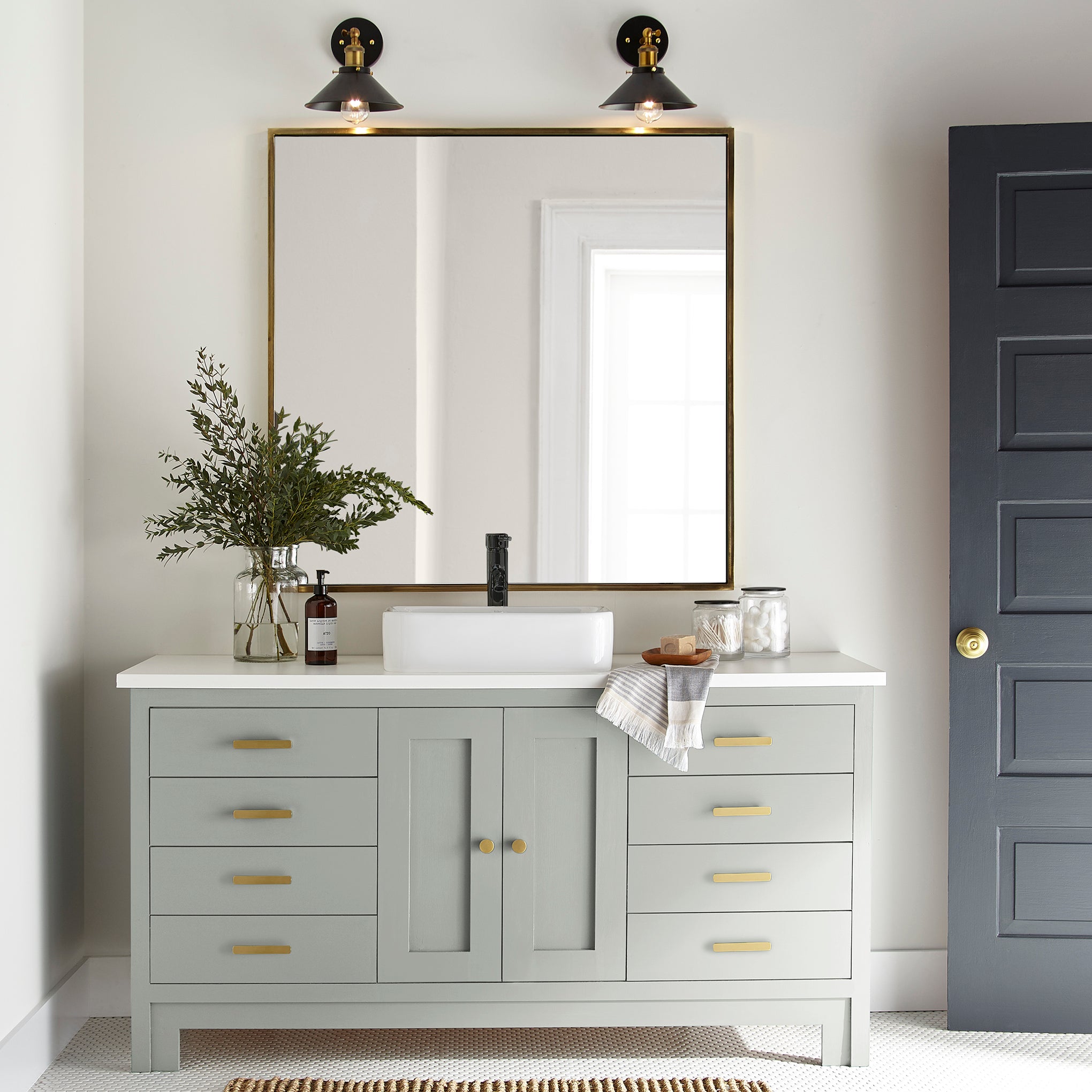 Light blue grey with light green undertone paint named Emmie's Room shown painted on bathroom cabinet.