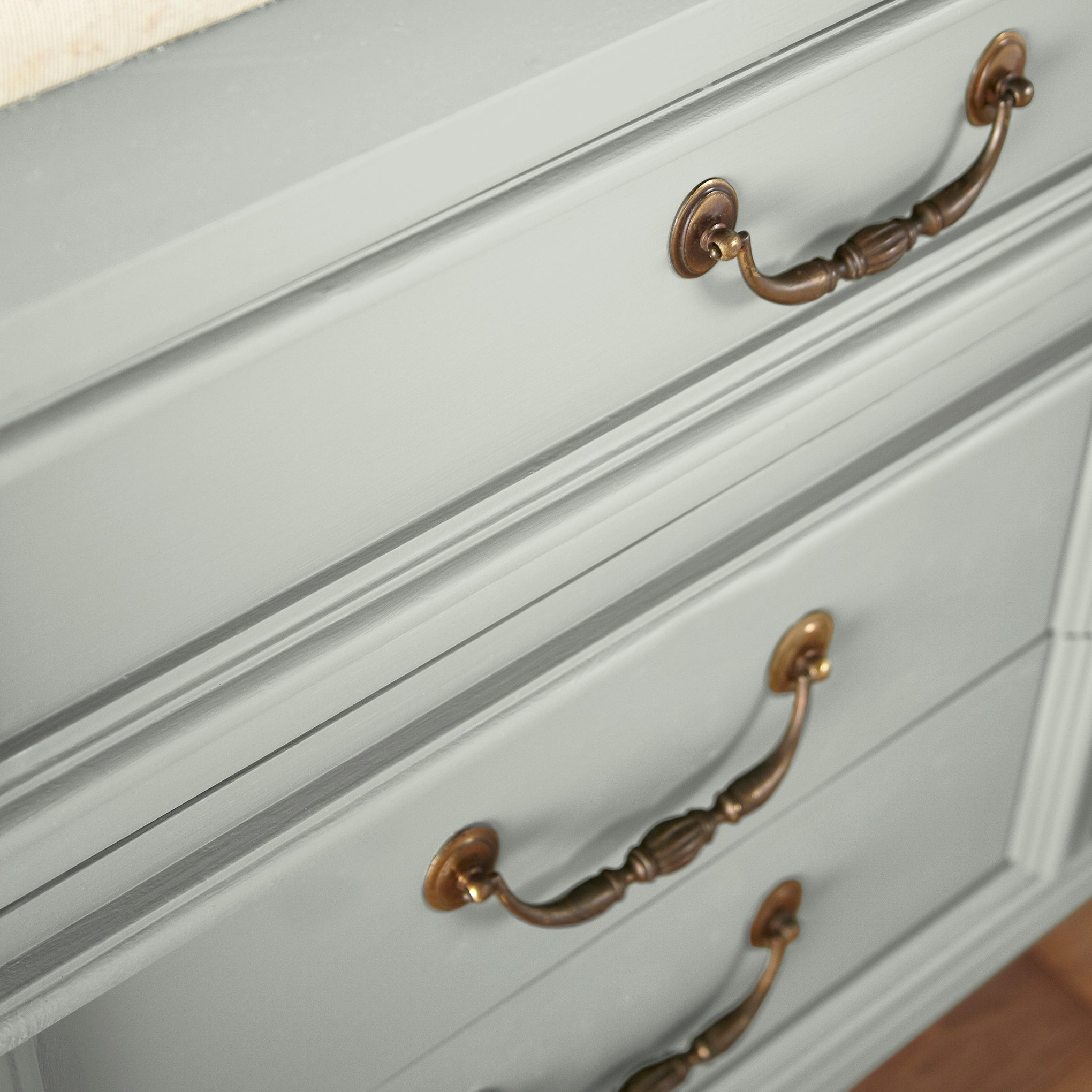 Light blue grey with light green undertone paint named Emmie's Room shown painted on cabinet.