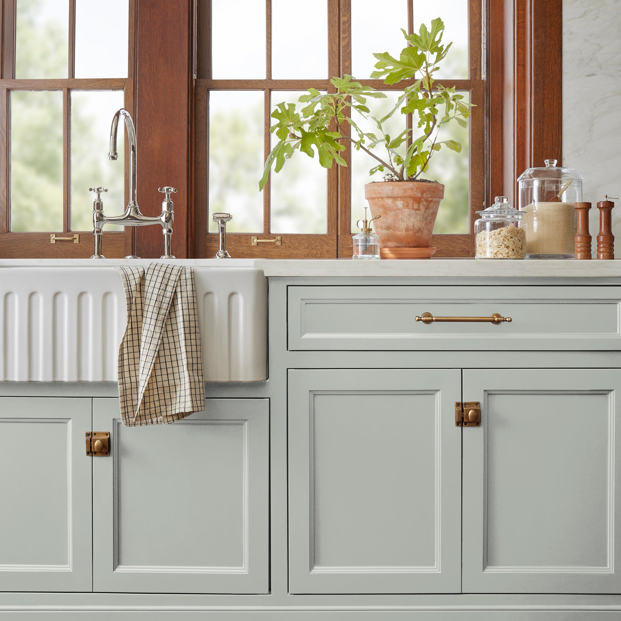 Silver gray tinted with sky blue door and cabinet paint named wedding band shown painted on kitchen cabinet