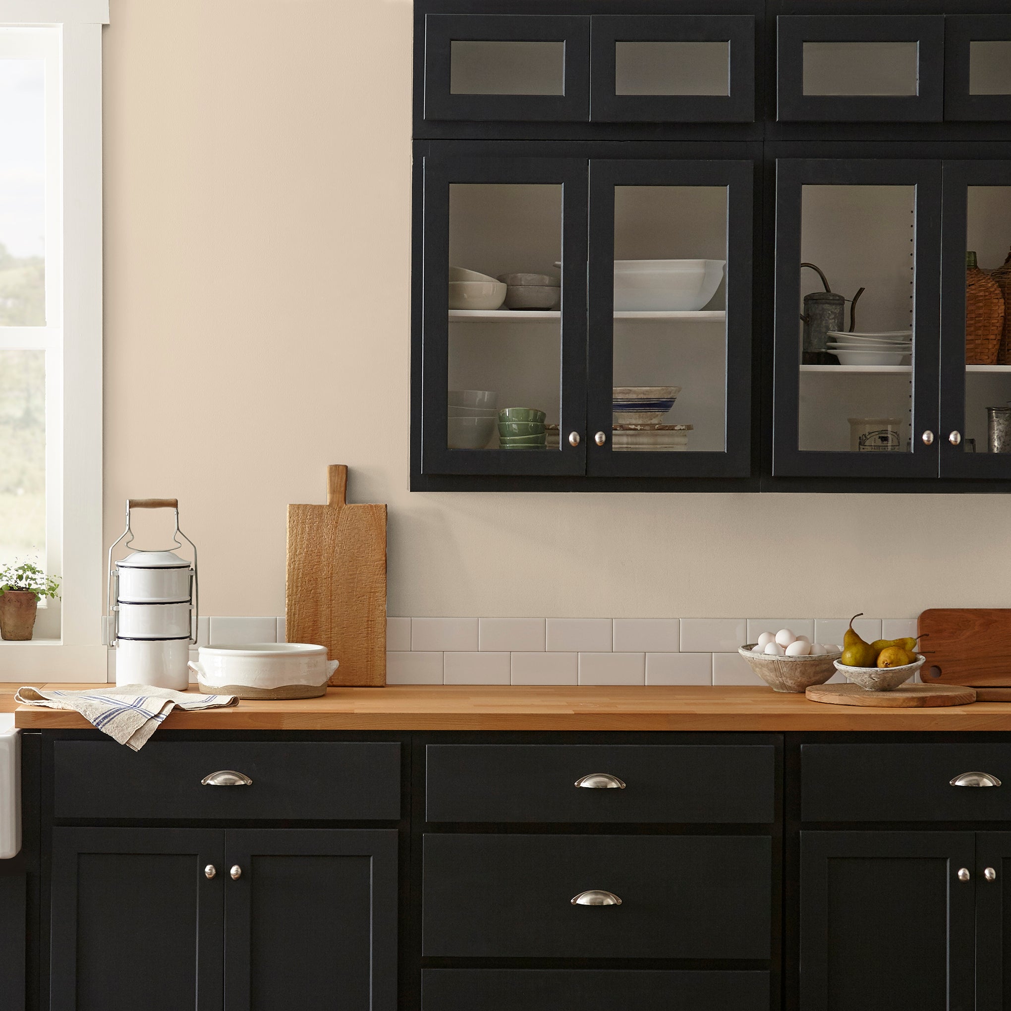 light tan with a yellow undertone paint named soft landing shown painted on kitchen wall