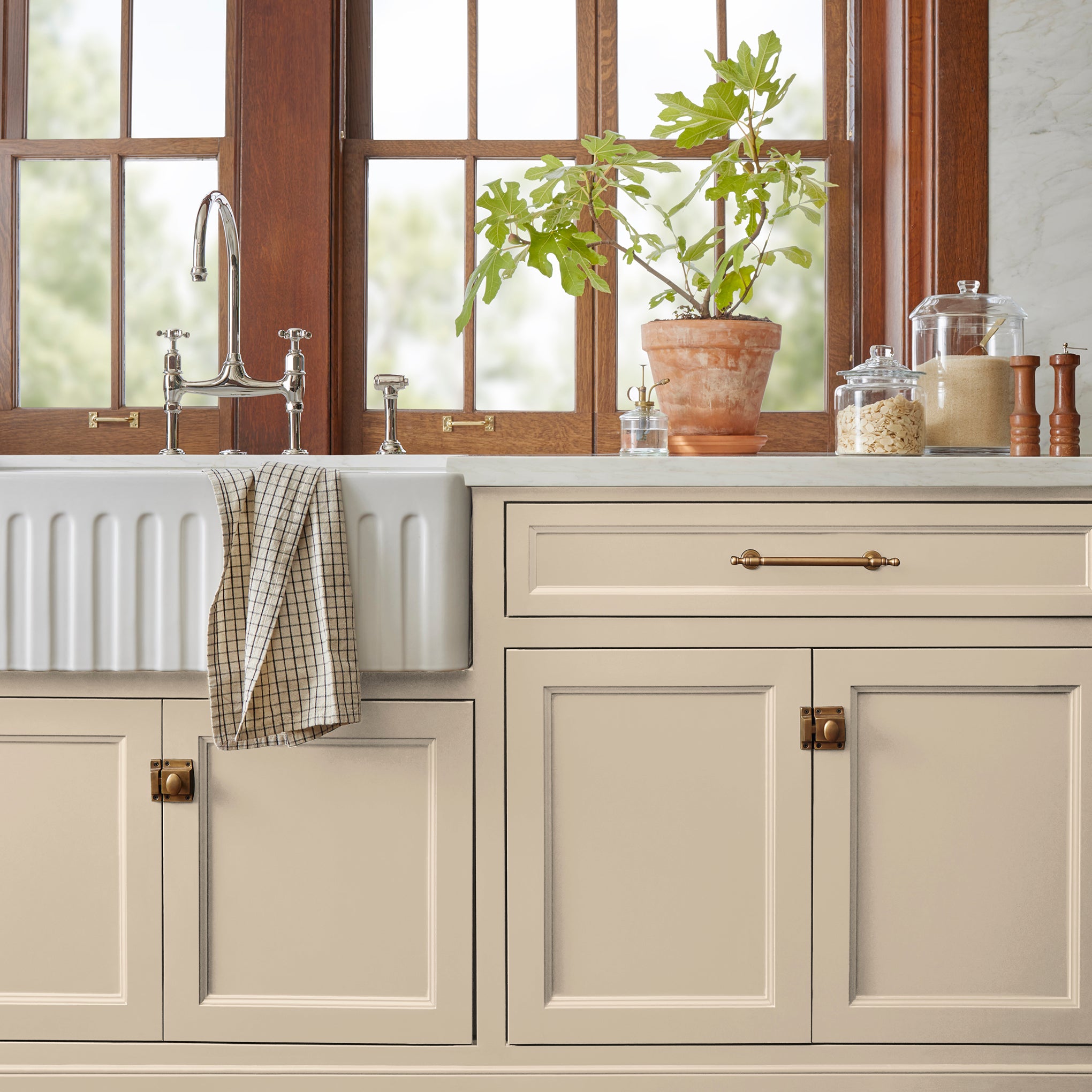 light tan with a yellow undertone door and cabinet paint named soft landing show painted on kitchen cabinet