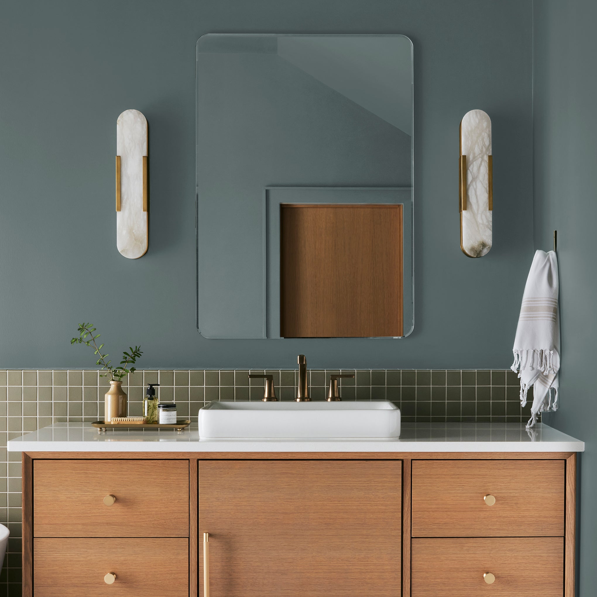 deep muted blue with grey undertones paint named duke gray shown painted on bathroom wall