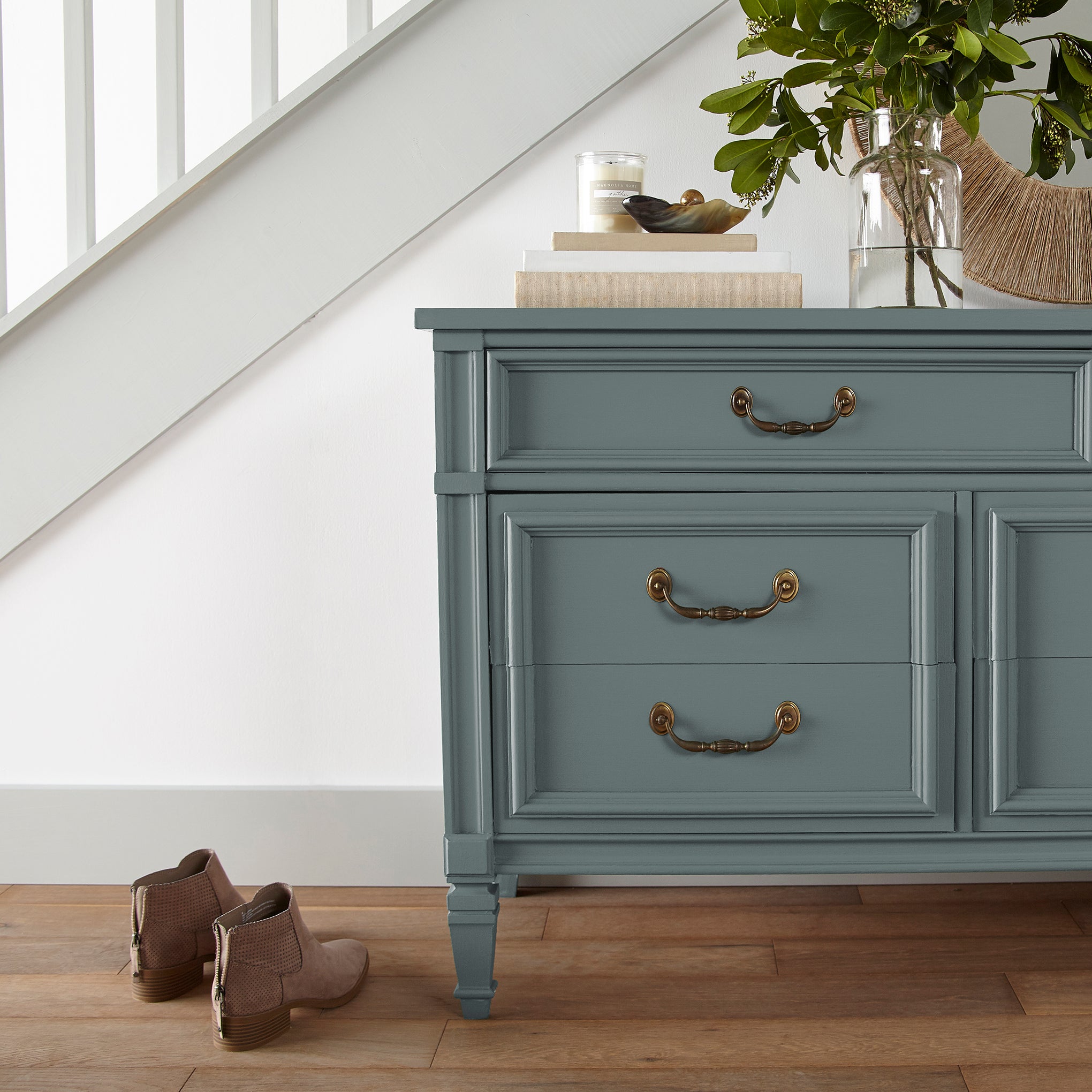 deep muted blue with grey undertones door and cabinet paint named duke gray shown painted on entryway cabinet
