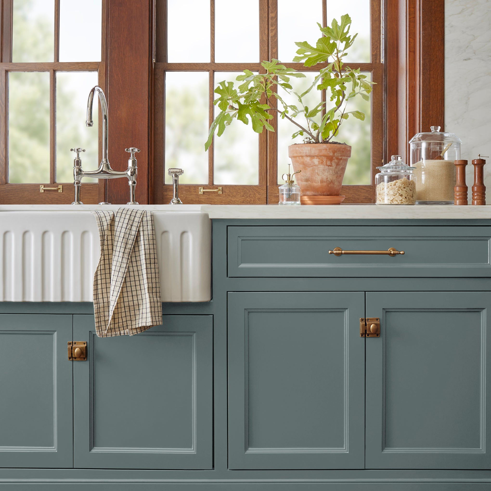 deep muted blue with grey undertones door and cabinet paint named duke gray shown painted on kitchen cabinet