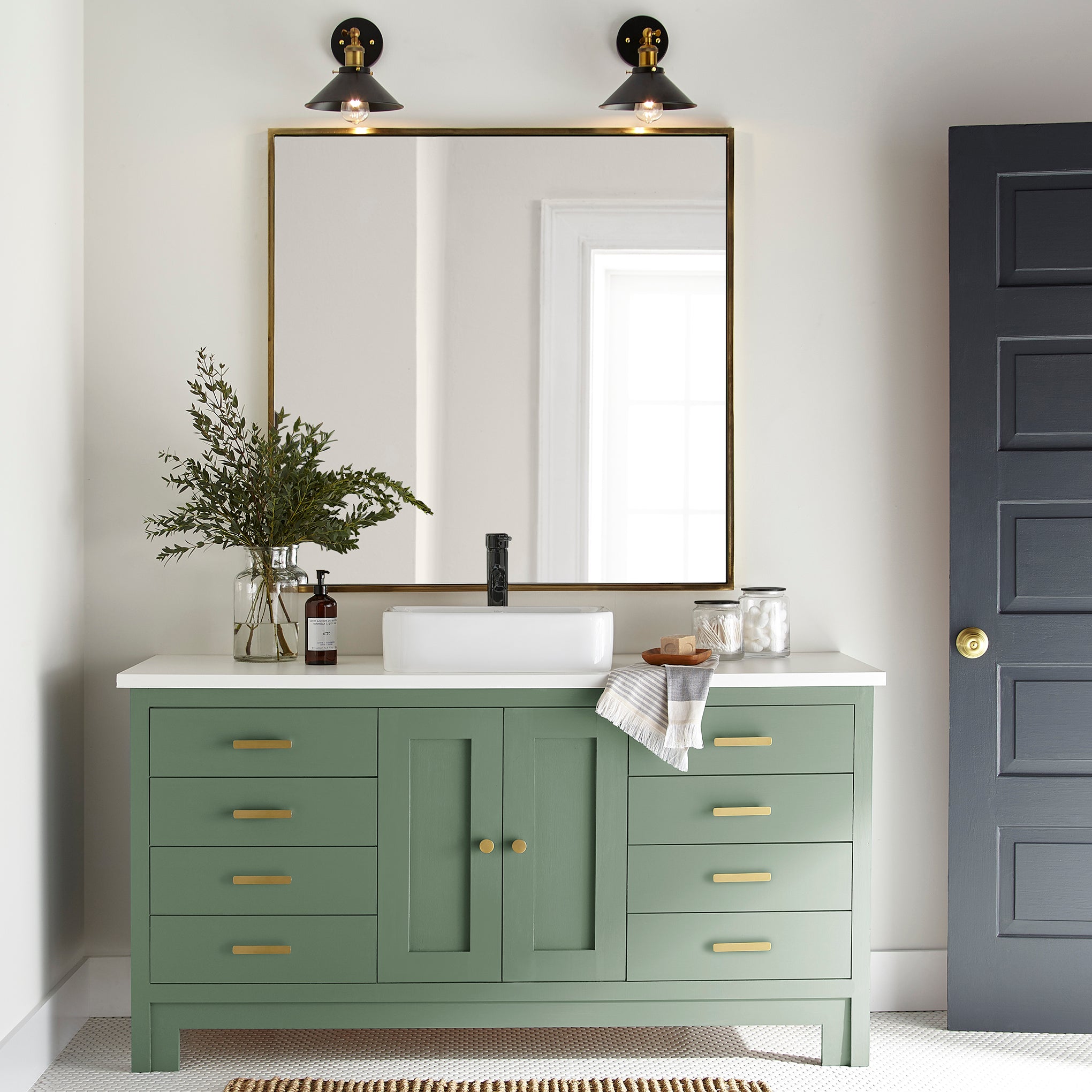 Bold and crisp green trim, door and cabinetry paint named Magnoliass Green shown painted onbathroom cabinet