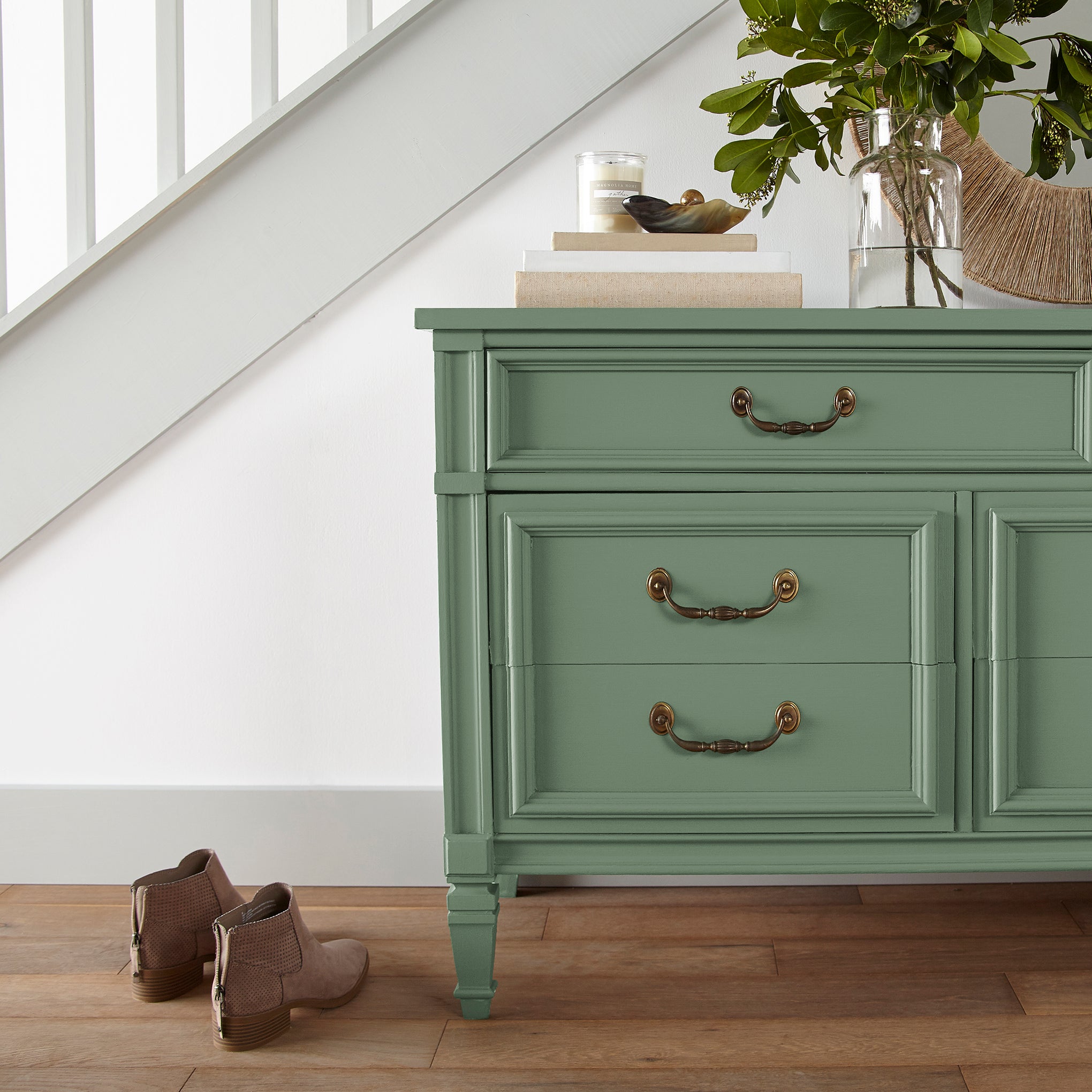Bold and crisp green trim, door and cabinetry paint named Magnoliass Green shown painted on entryway cabinet