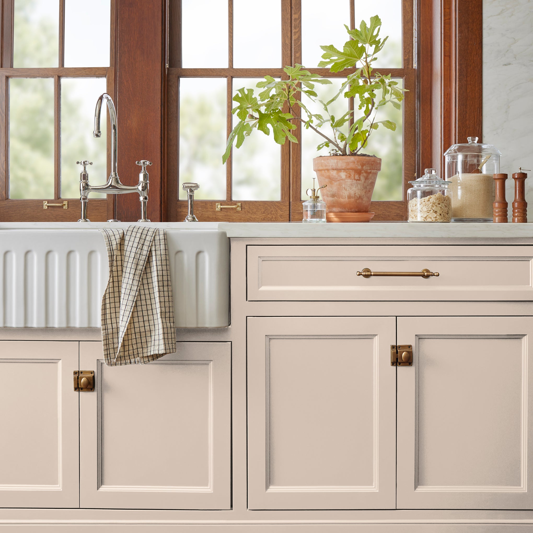 Warm soft peach trim, door and cabinetry paint named dutch tulip shown painted on kitchen cabinet