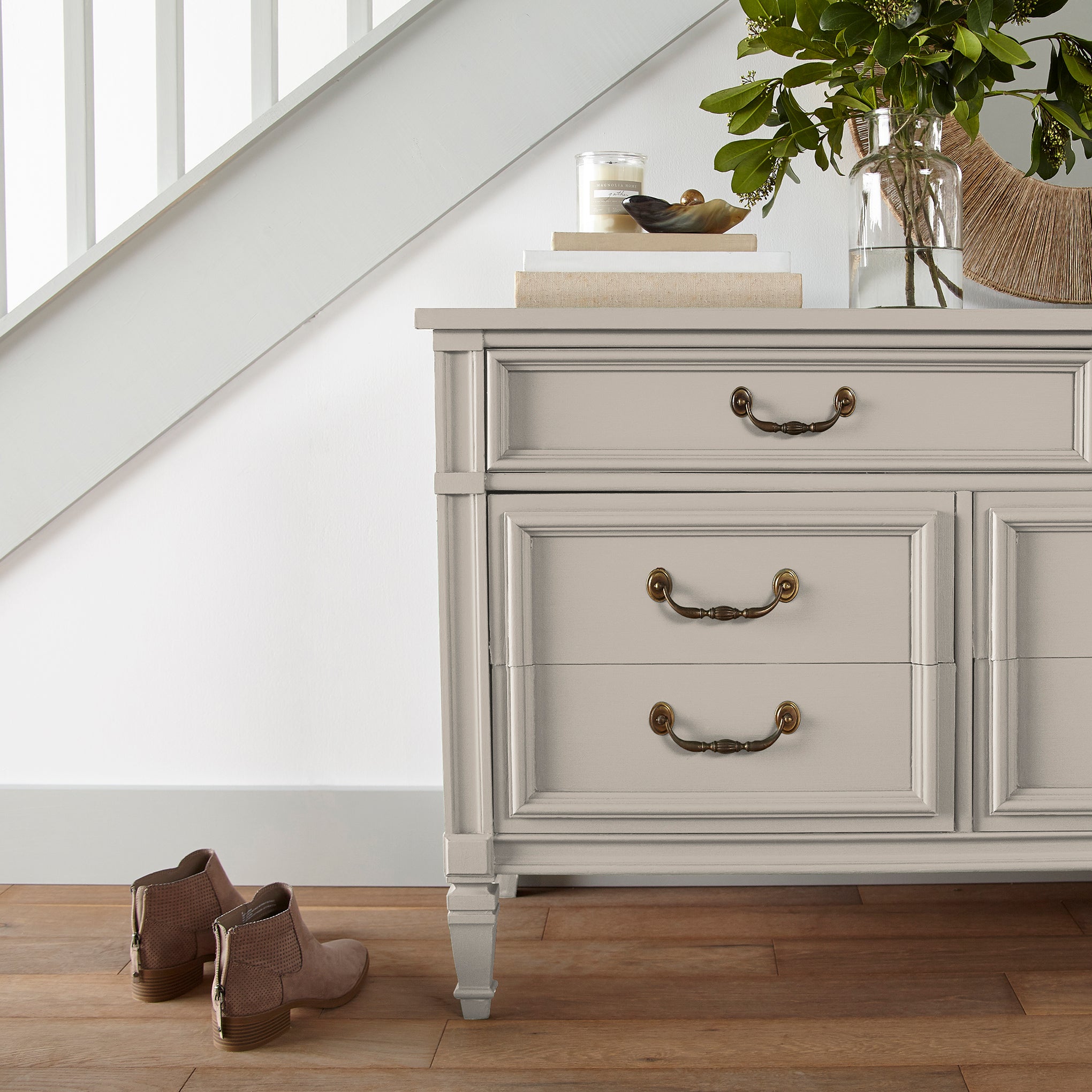 Oatmeal white with peach accents door and cabinet paint named Soft Linen shown painted on entryway cabinet