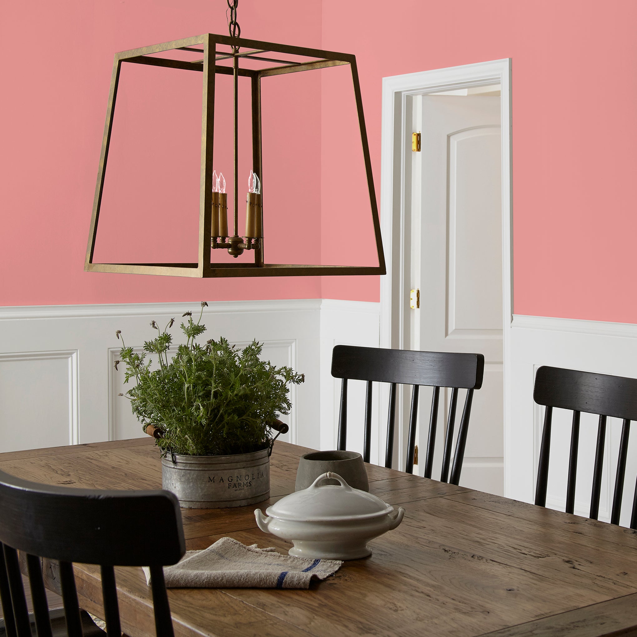 Coral pink interior paint named pink lemonade shown painted on dining room wall