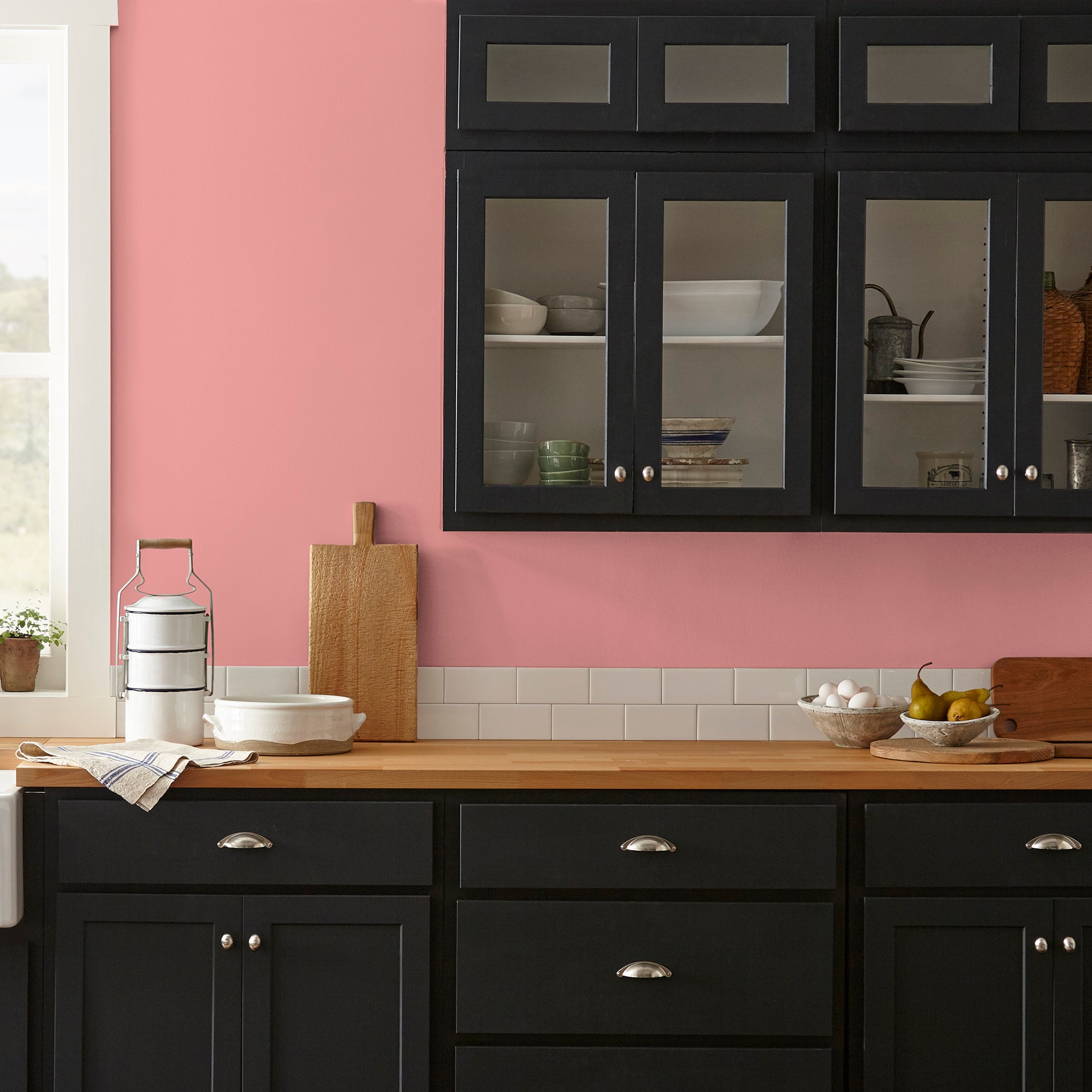 Coral pink interior paint named pink lemonade shown painted on kitchen wall