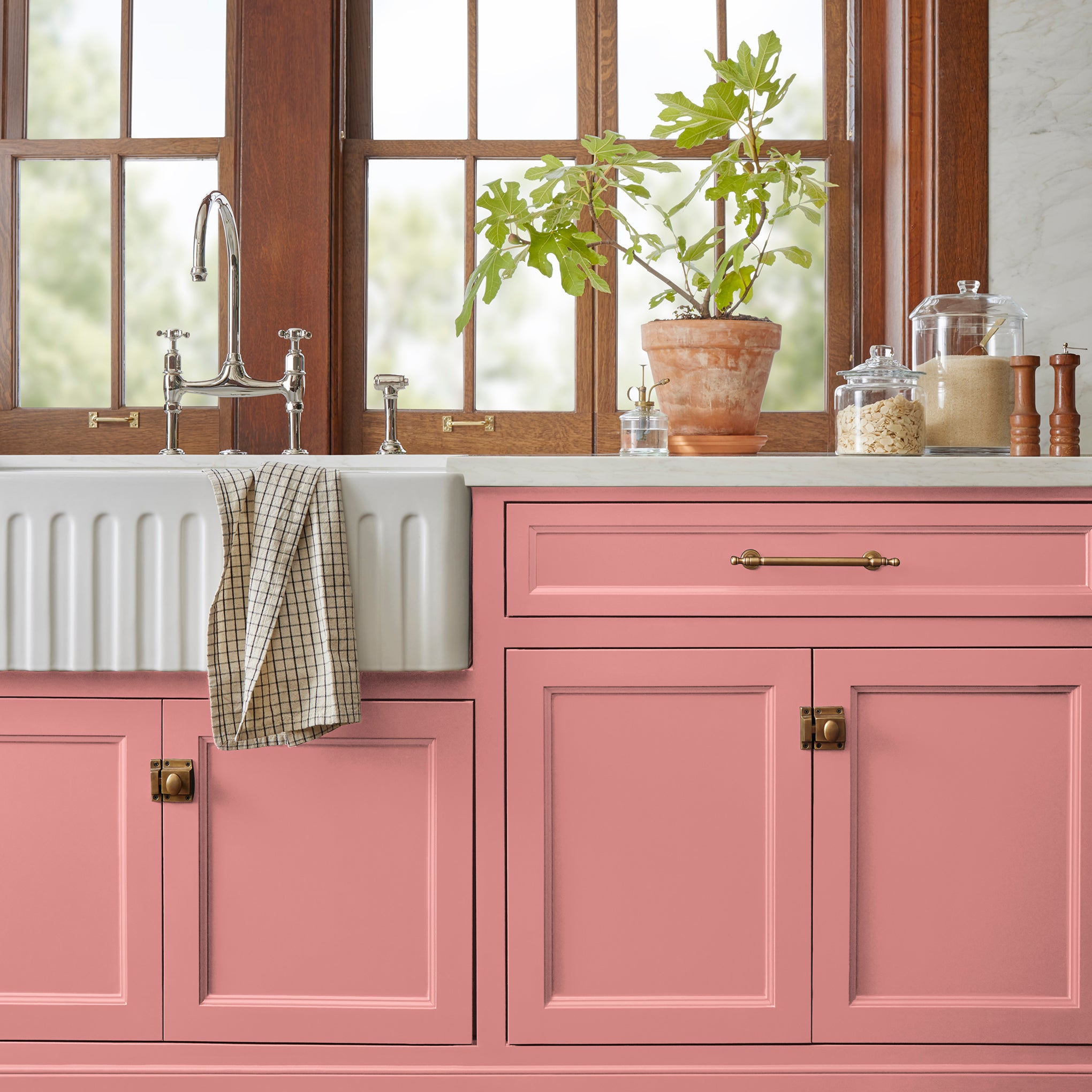a coral pink trim, door and cabinetry paint named pink lemonade shown painted on kitchen cabinet