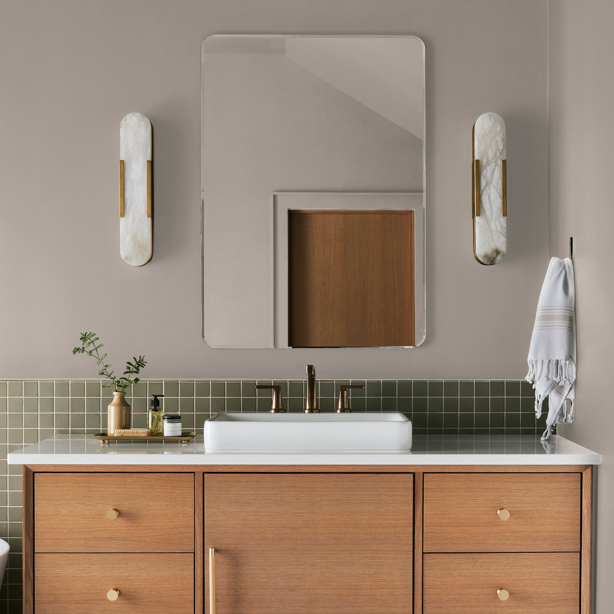 Sandy tan with pink notes interior paint named cinnamon sugar shown painted on bathroom wall