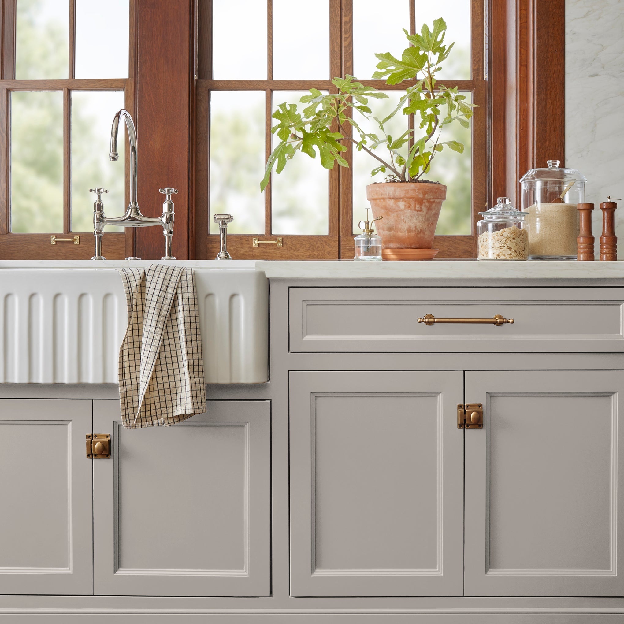 A mid-toned taupe door and cabinet paint named timeless look shown painted on kitchen cabinet