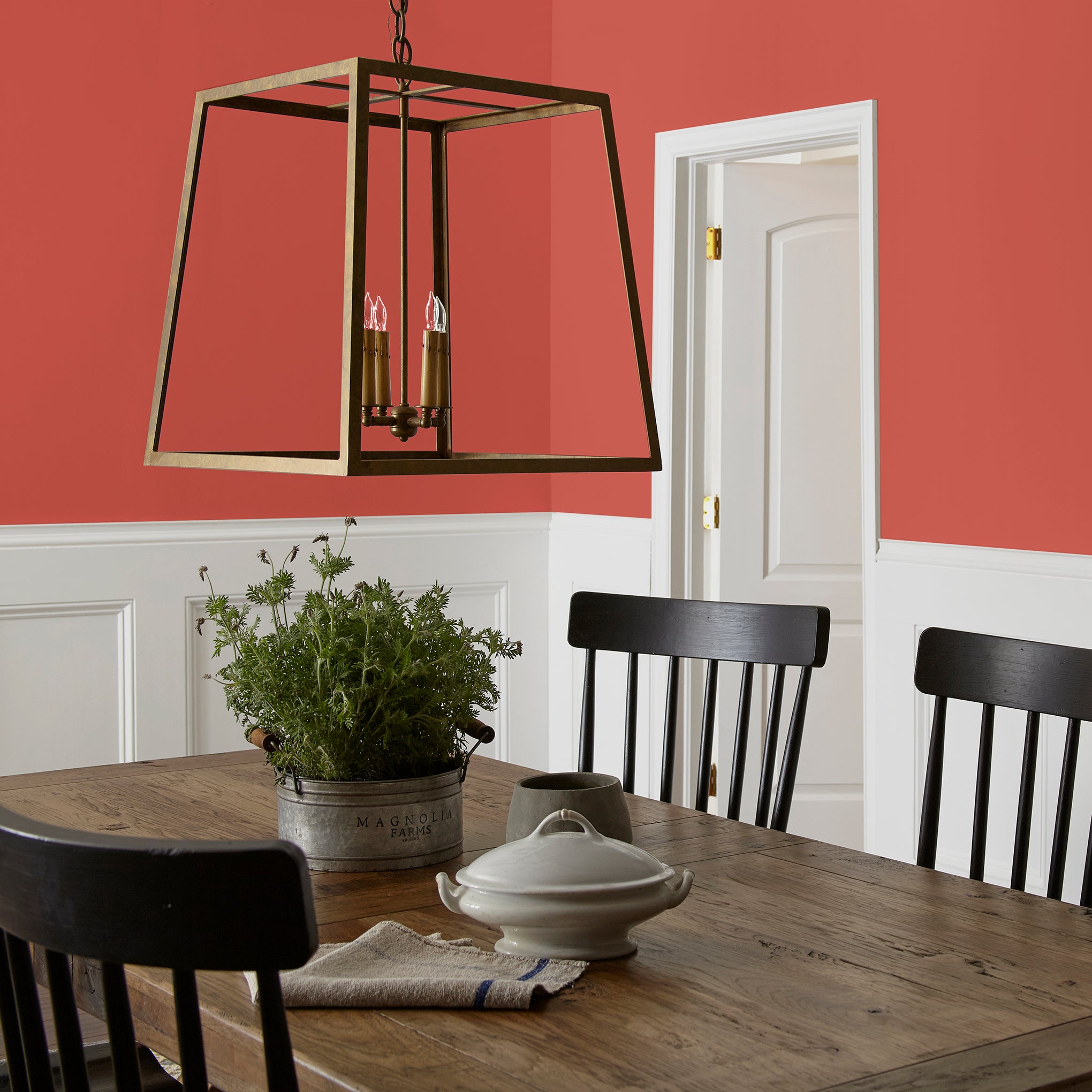 Bright red interior paint named hopscotch shown painted on dining room wall