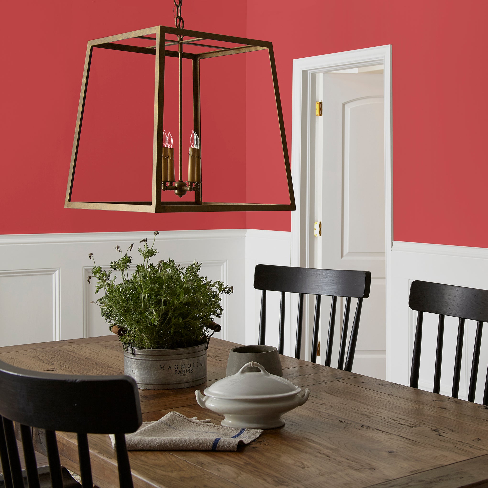 Bright pomegranate red interior paint named brave and bold shown painted on dining room wall