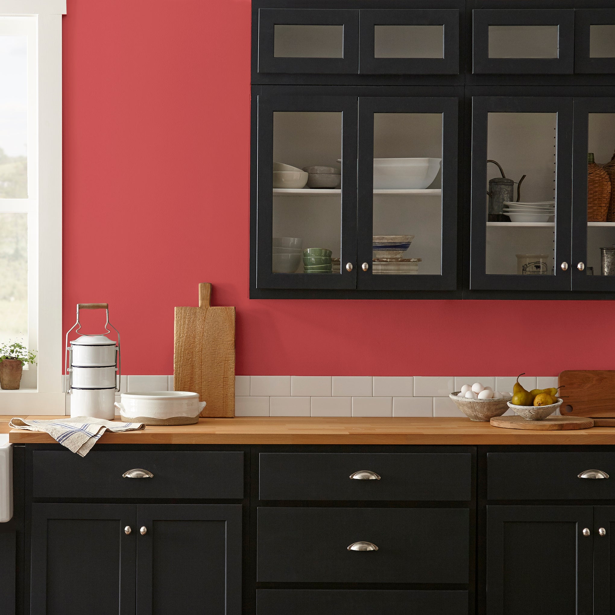 Bright pomegranate red interior paint named brave and bold shown painted on kitchen wall
