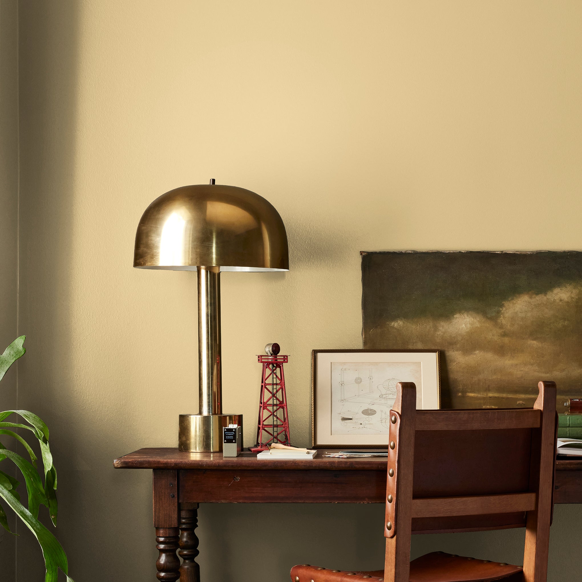 muted yellow with green undertones paint named heirloom yellow shown painted on bedroom wall