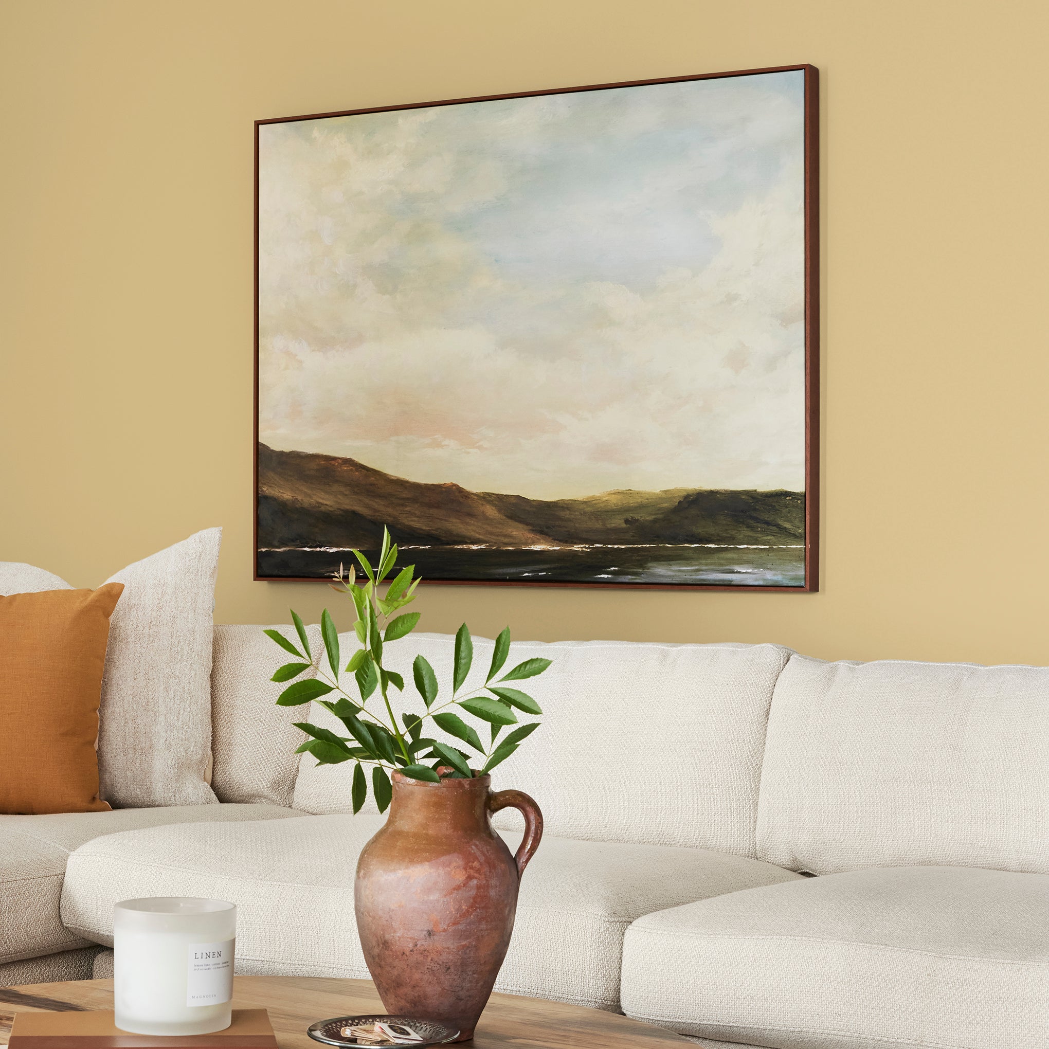 muted yellow with green undertones paint named heirloom yellow shown painted on living room wall