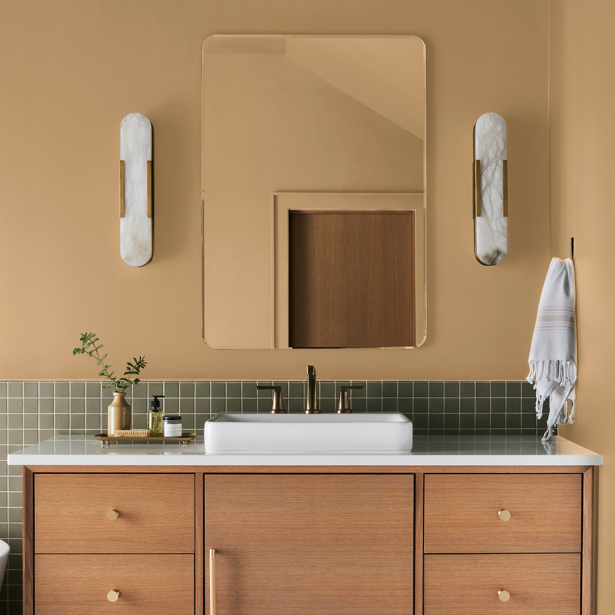 Muted mid-toned yellow interior paint named cottage feel shown painted on bathroom wall