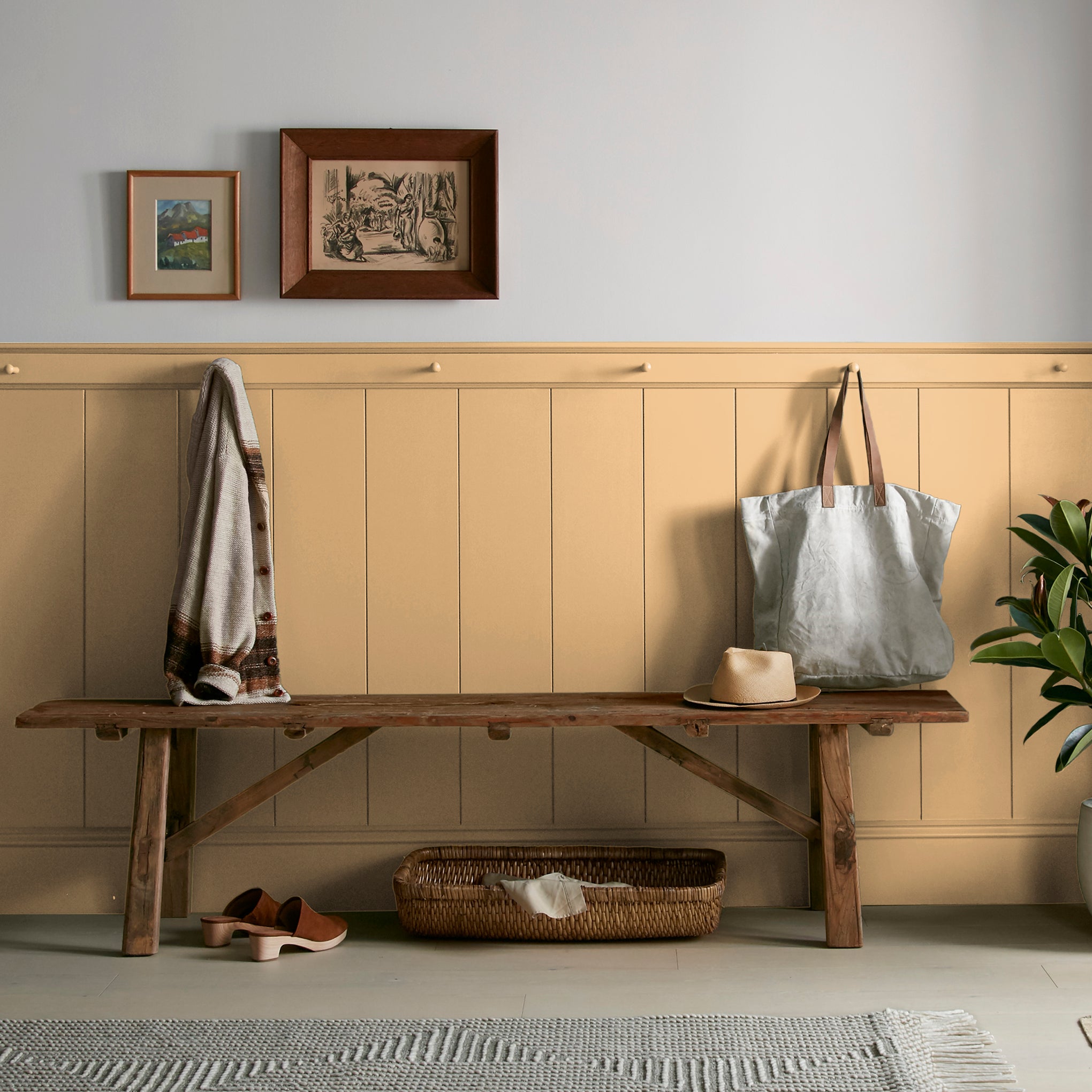 Muted mid-toned yellow interior paint named cottage feel shown painted on entryway wall