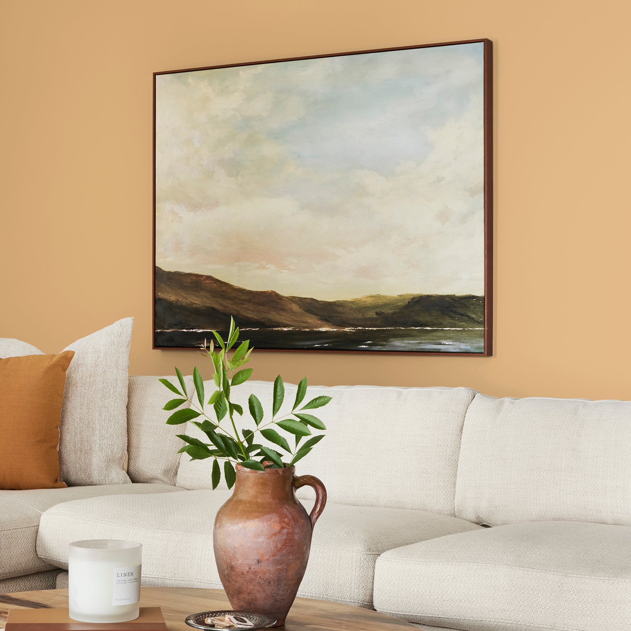 Muted mid-toned yellow interior paint named cottage feel shown painted on living room wall