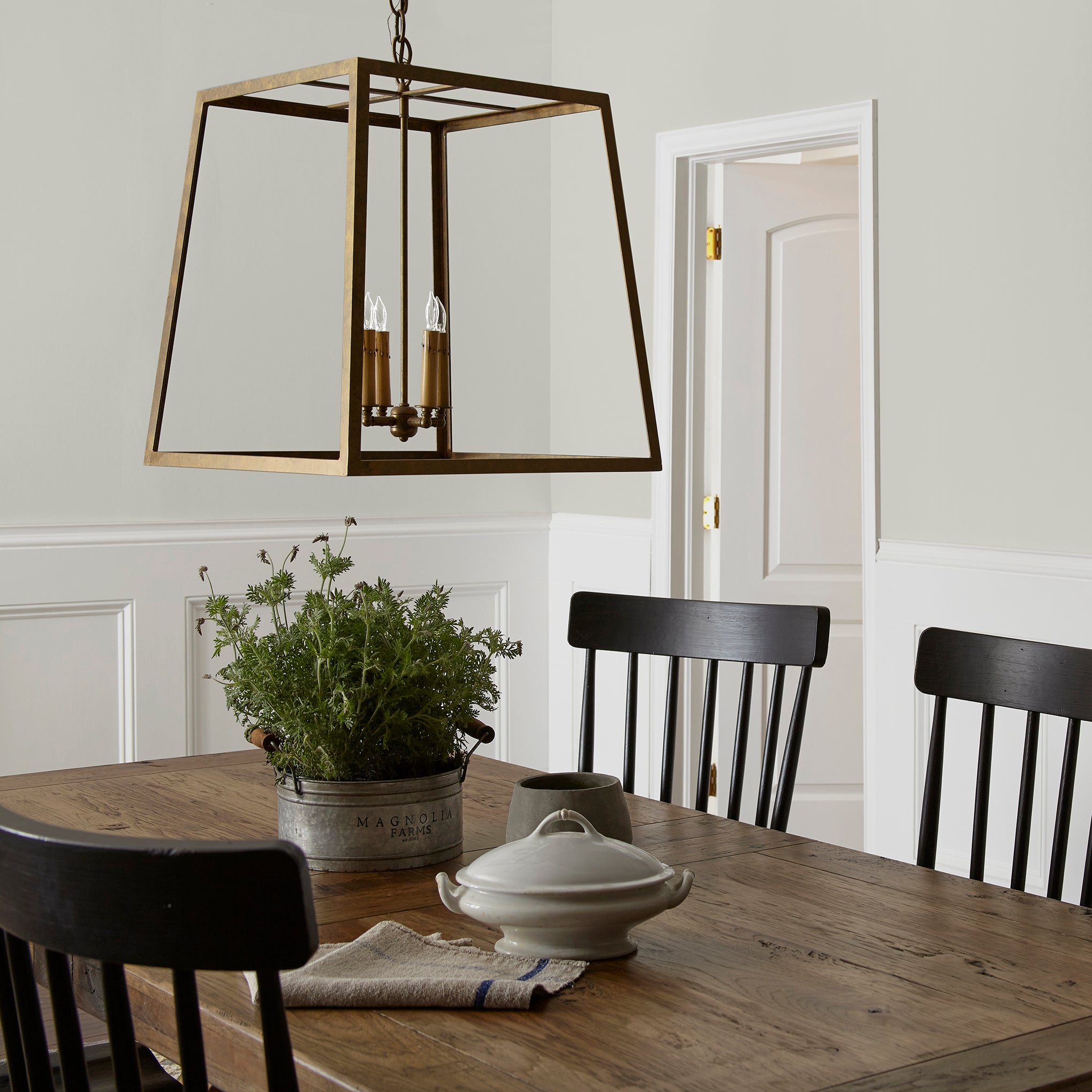 Light gray with green undertone paint named piece of cake shown painted on dining room wall
