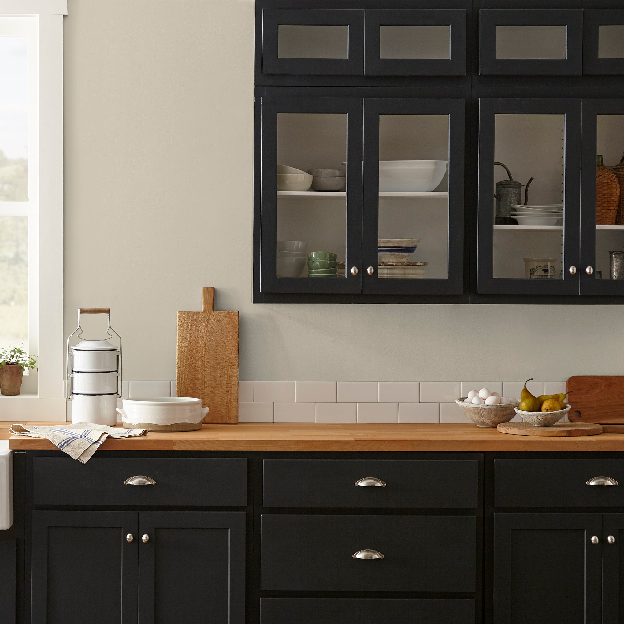 A light khaki green interior paint named summer hay shown painted on kitchen wall