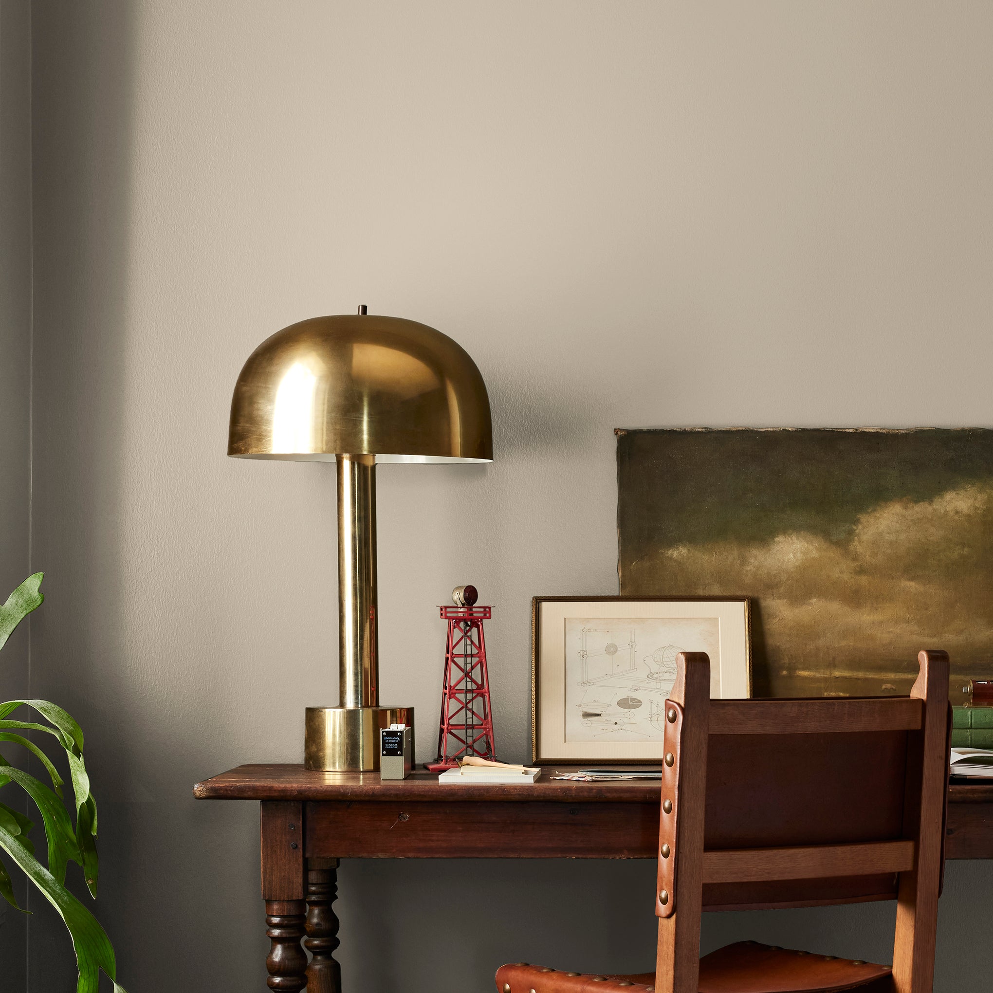 A khaki green interior paint named gold moss shown painted on bedroom wall