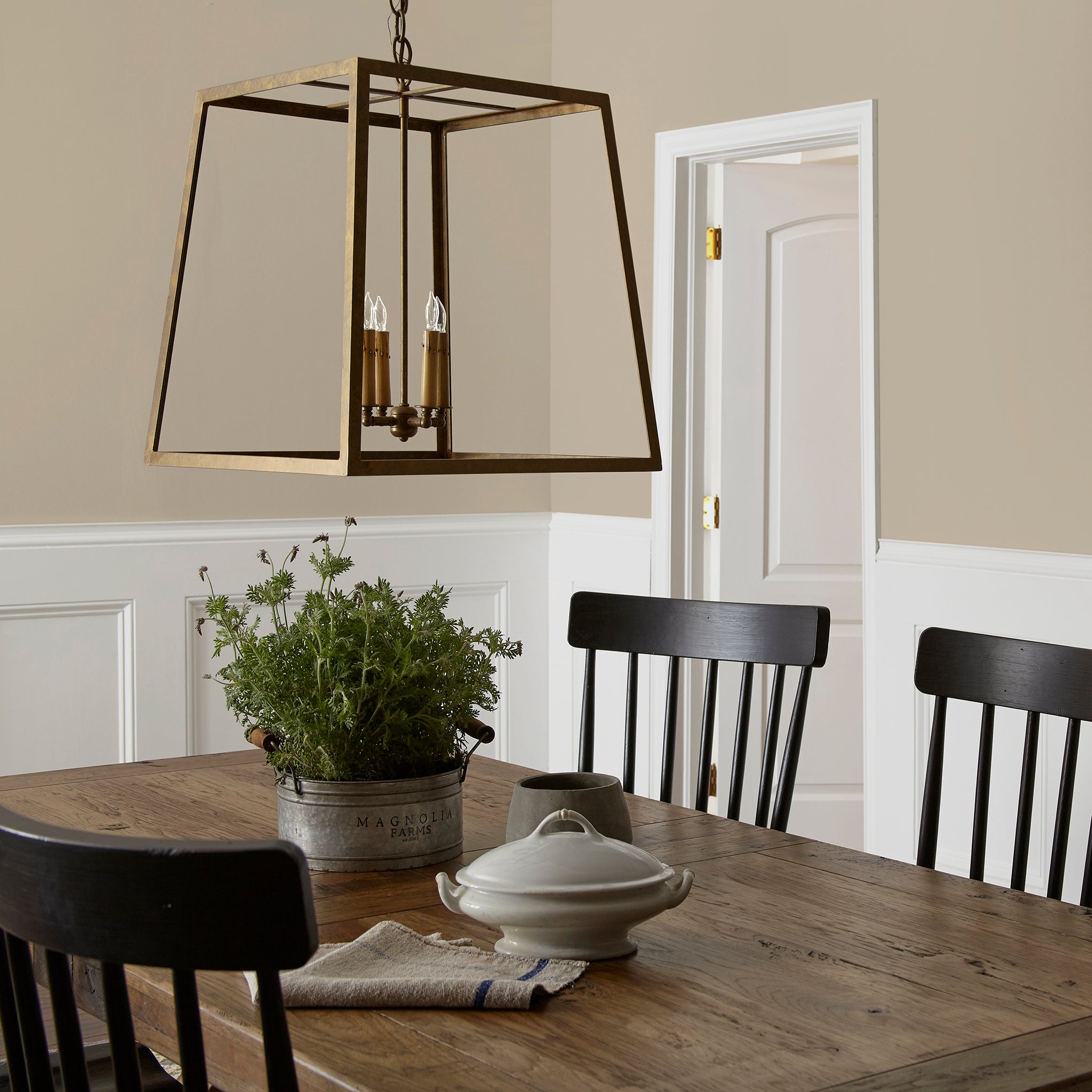 A khaki green interior paint named gold moss shown painted on dining room wall