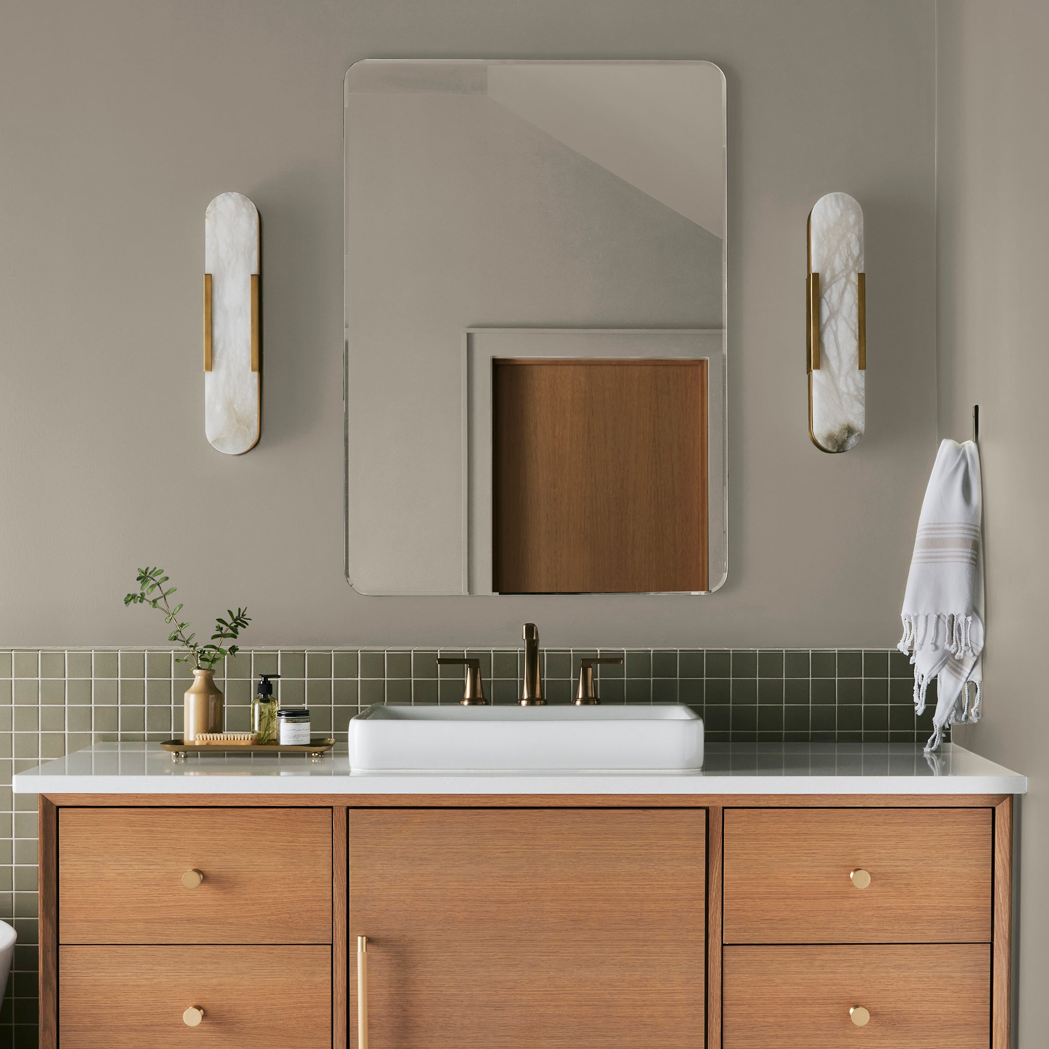 Mid-toned tan with a hint of green interior paint named renewed shown painted on bathroom wall