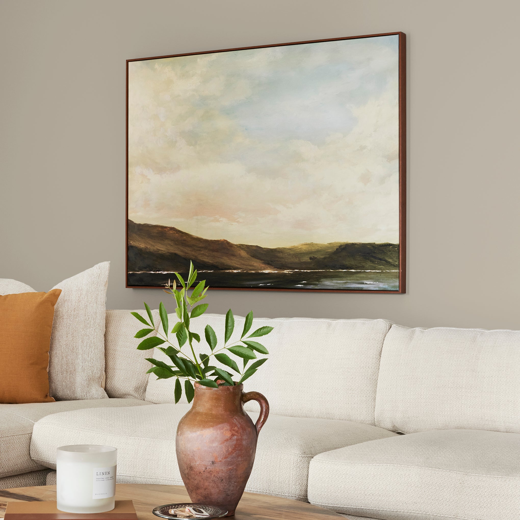 Mid-toned tan with a hint of green interior paint named renewed shown painted on living room wall