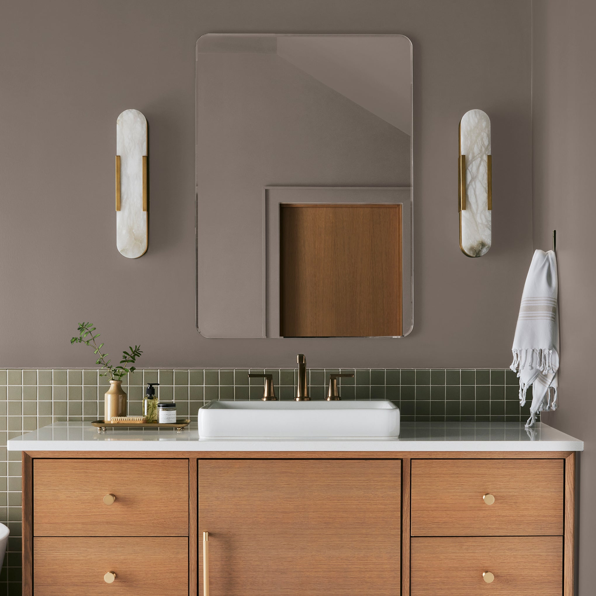 A warm brown with yellow accents interior paint named elemental shown painted on bathroom wall