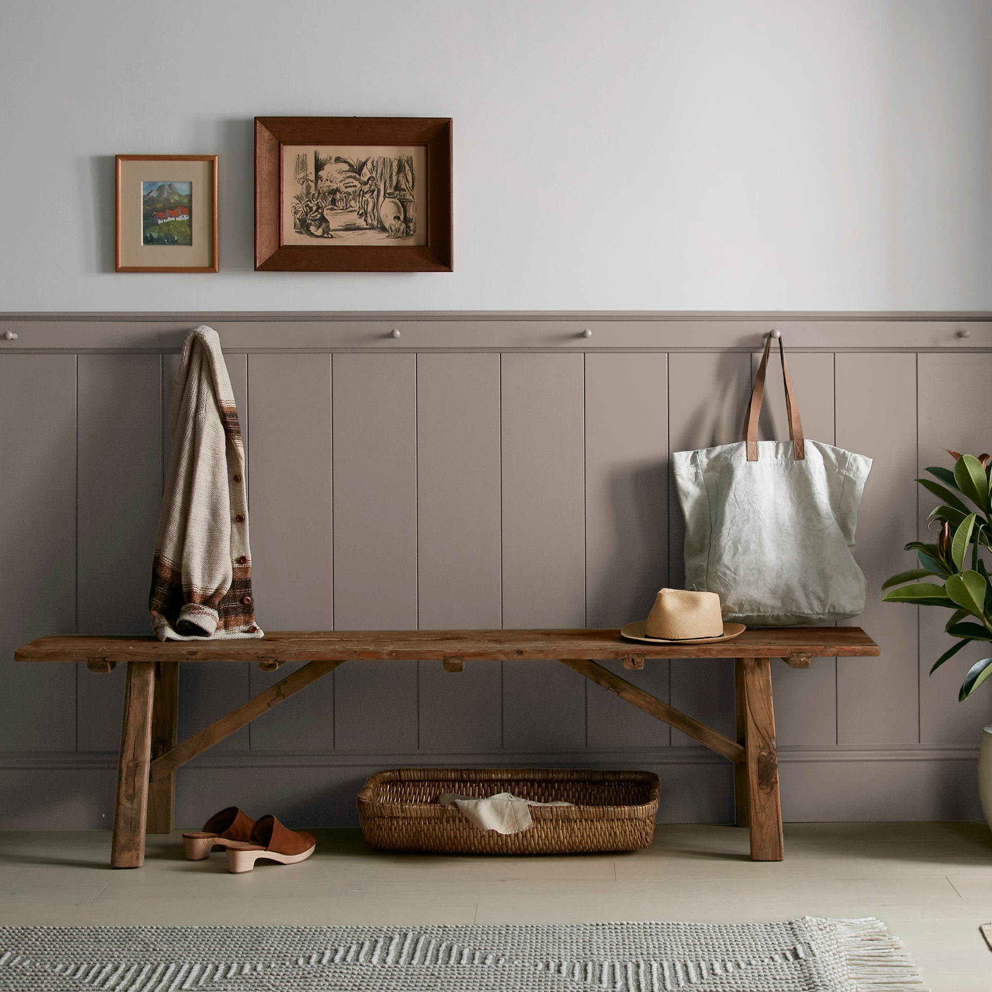 A warm brown with yellow accents interior paint named elemental shown painted on entryway wall