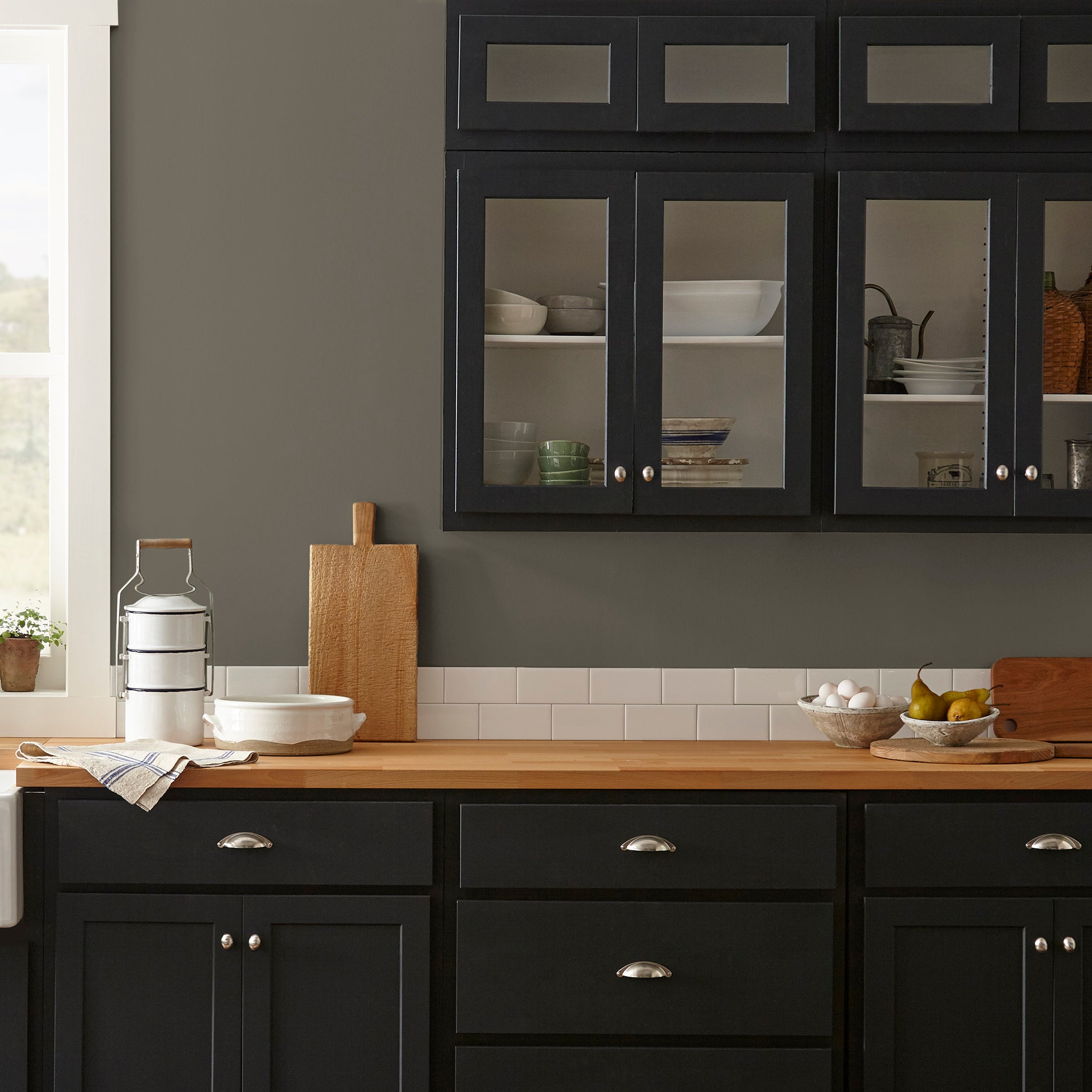 Woodsy brown with a touch of green interior paint named wooded acres shown painted on kitchen wall