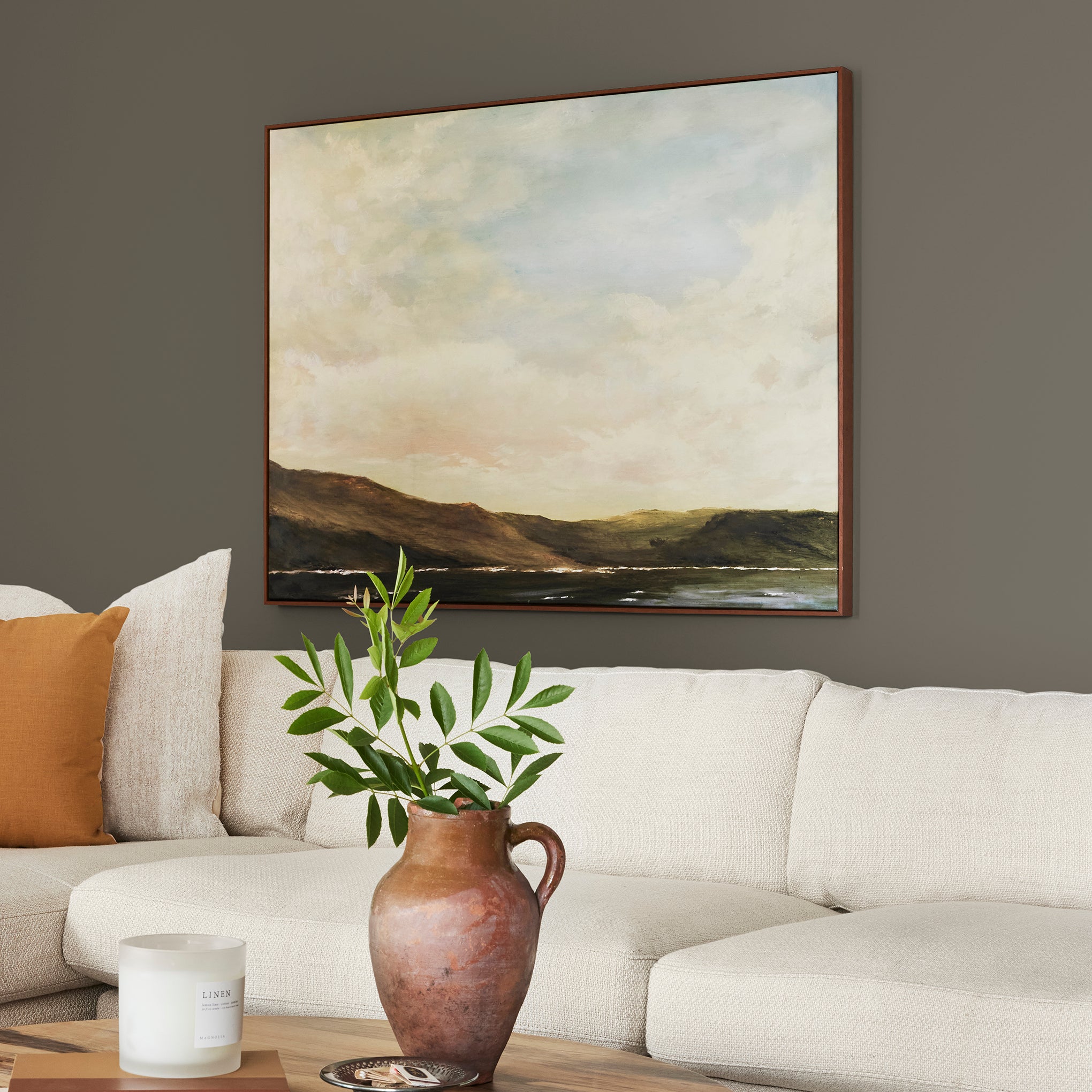 Woodsy brown with a touch of green interior paint named wooded acres shown painted on living room wall