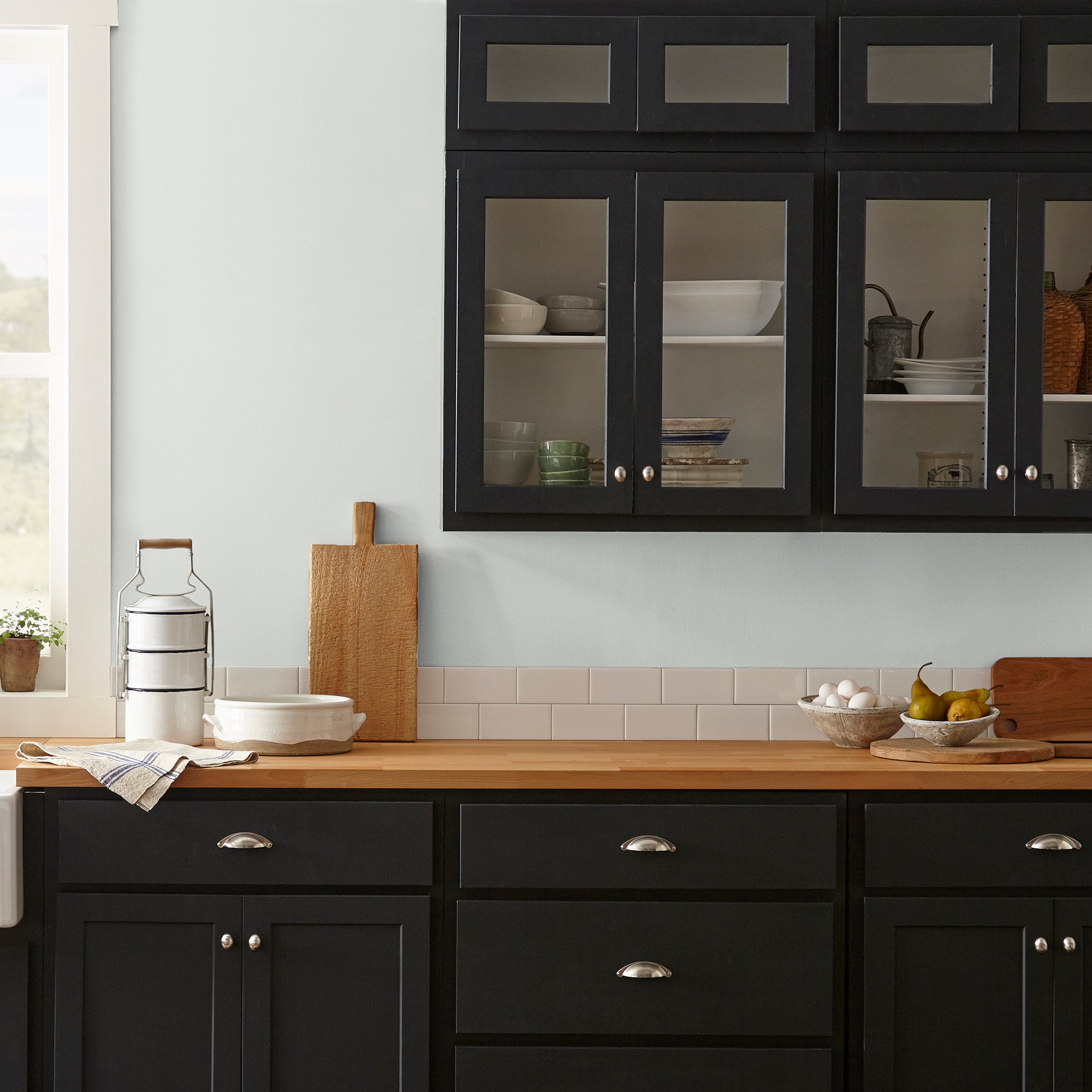 Almost white blended with gray tones interior paint named cloudy gray shown painted on kitchen wall