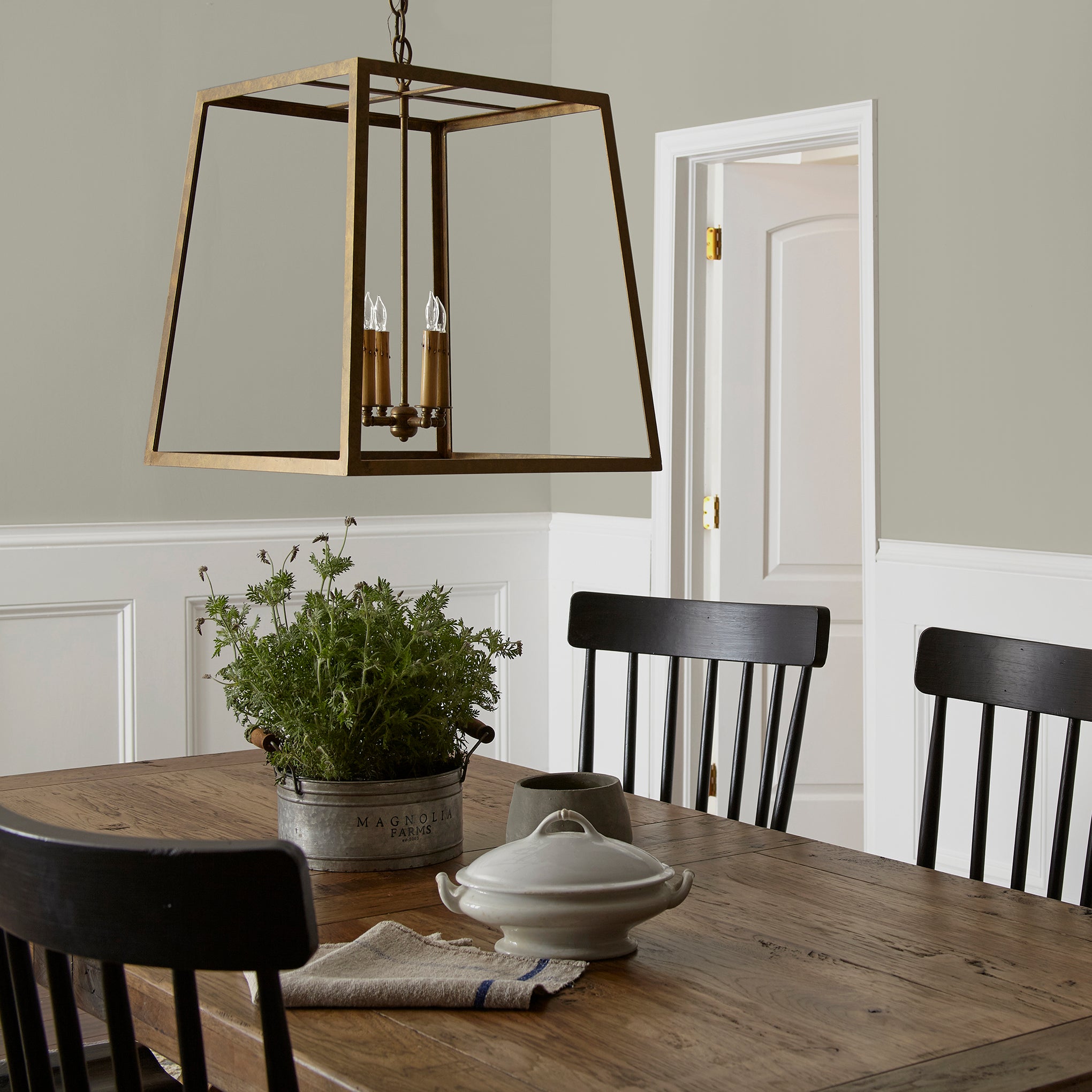 Warm chalky pale green interior paint named flower jar shown painted on dining room wall