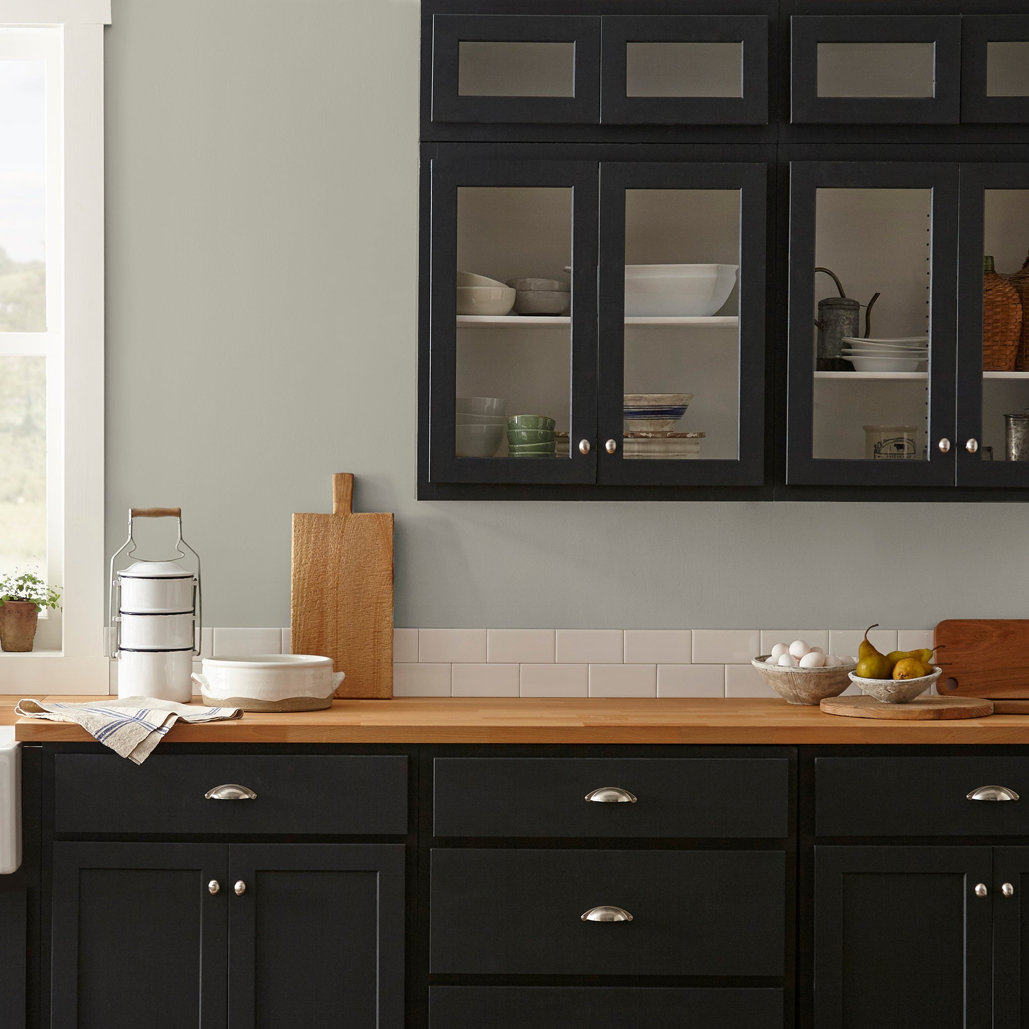 Warm chalky pale green interior paint named flower jar shown painted on kitchen wall