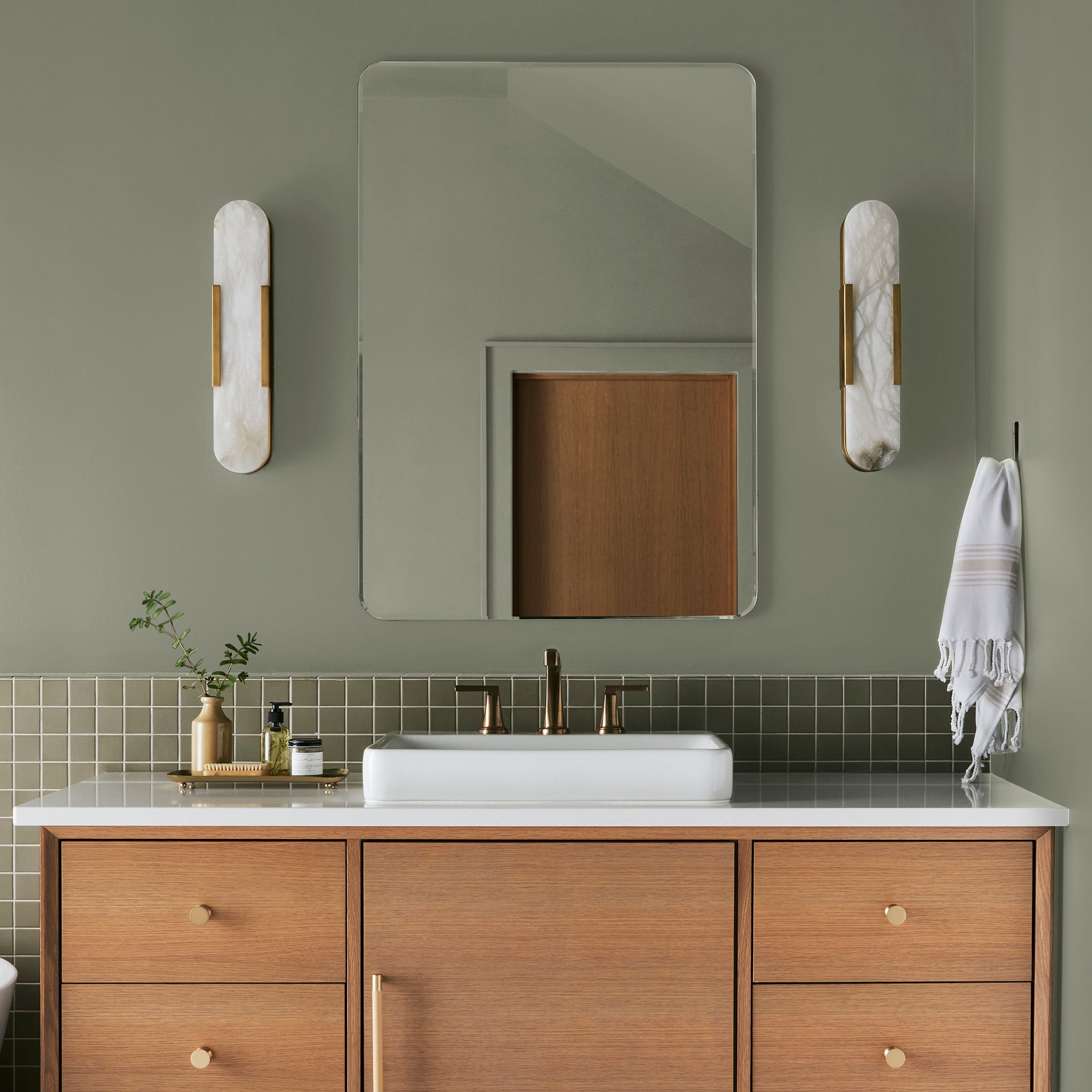 dark grey-green interior paint named garden essential shown painted on bathroom wall